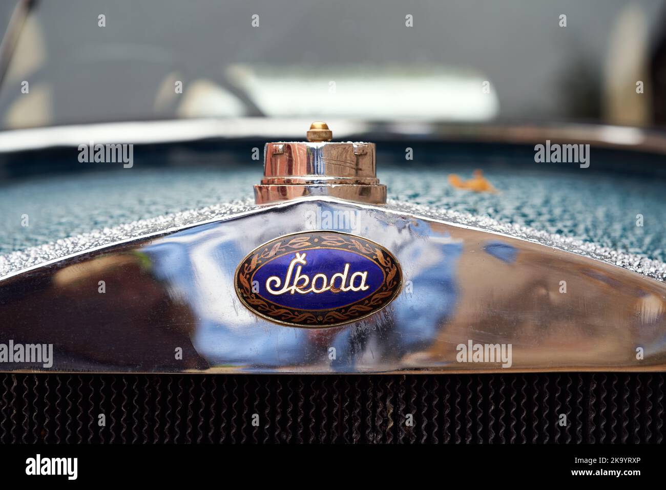 PRAGUE, CZECH REPUBLIC - OCTOBER 1, 2022: Close up of Skoda logo on a blue vintage car with droplets of water Stock Photo