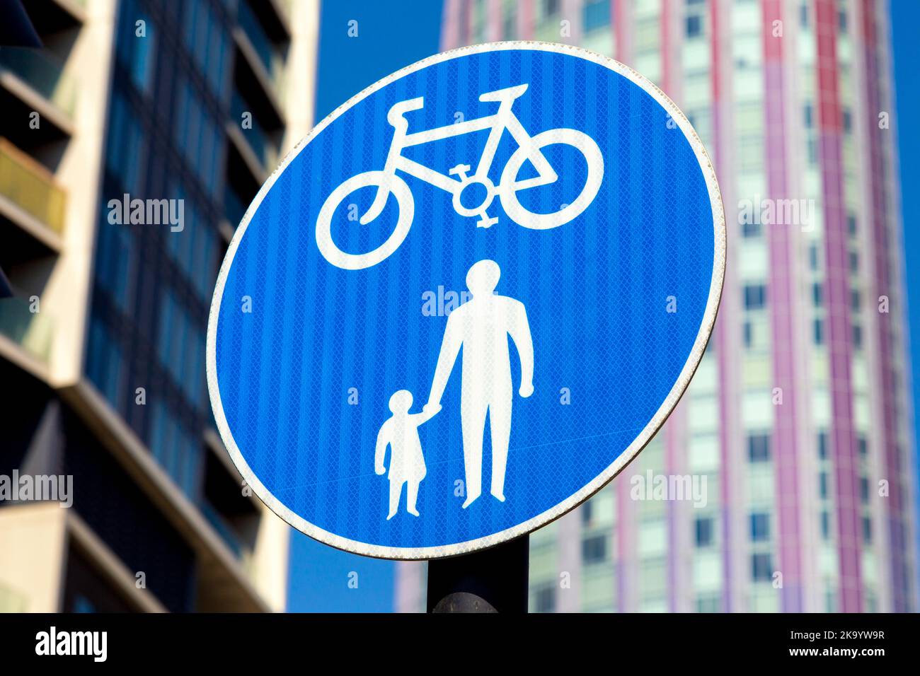 Right of way to cyclists and pedestrians blue road sign Stock Photo