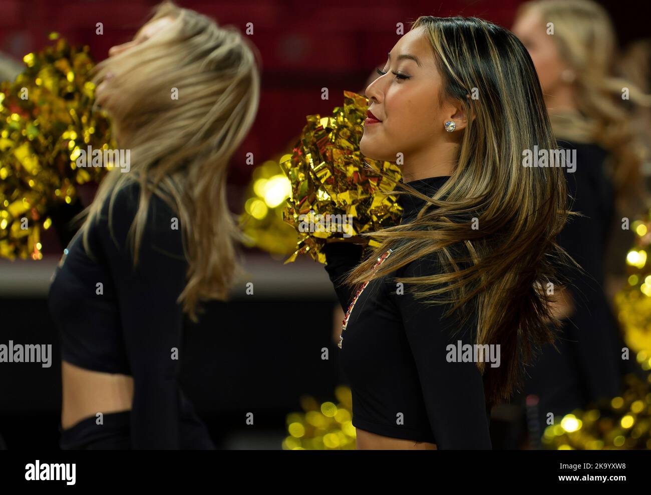 Cheerleader performs during a college basketball game Stock Photo