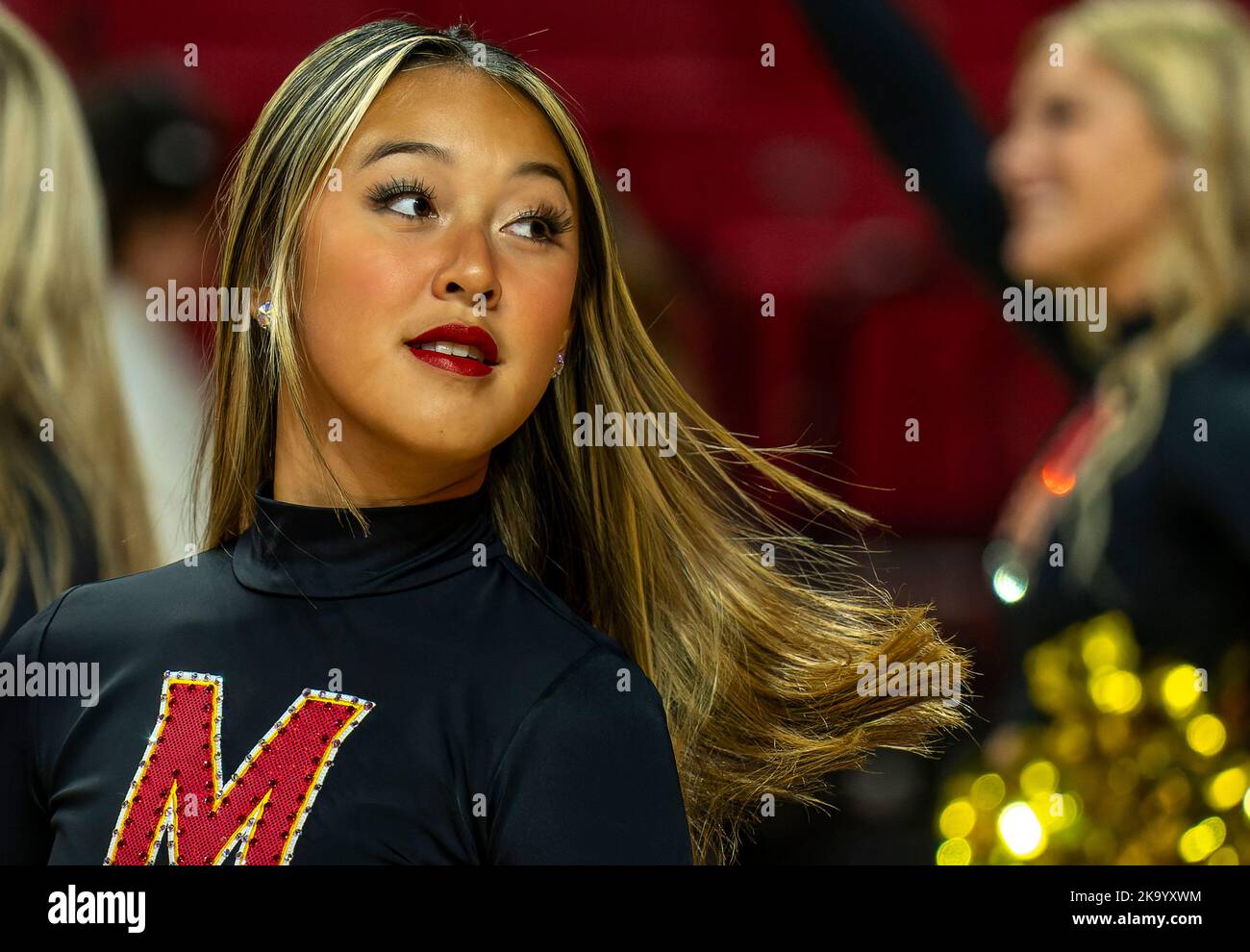 Cheerleader performs during a college basketball game Stock Photo