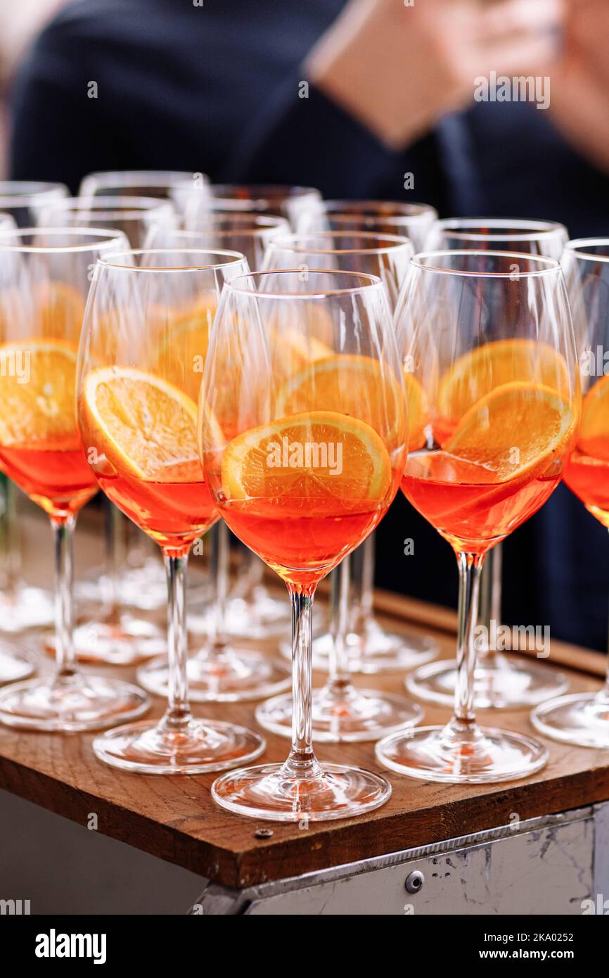 Glasses of alcoholic Aperol Spritz cocktail. Italian aperitif with ice,  aperol, prosecco, soda and slice of orange in large round glasses on party.  Celebration concepts festive days Stock Photo - Alamy