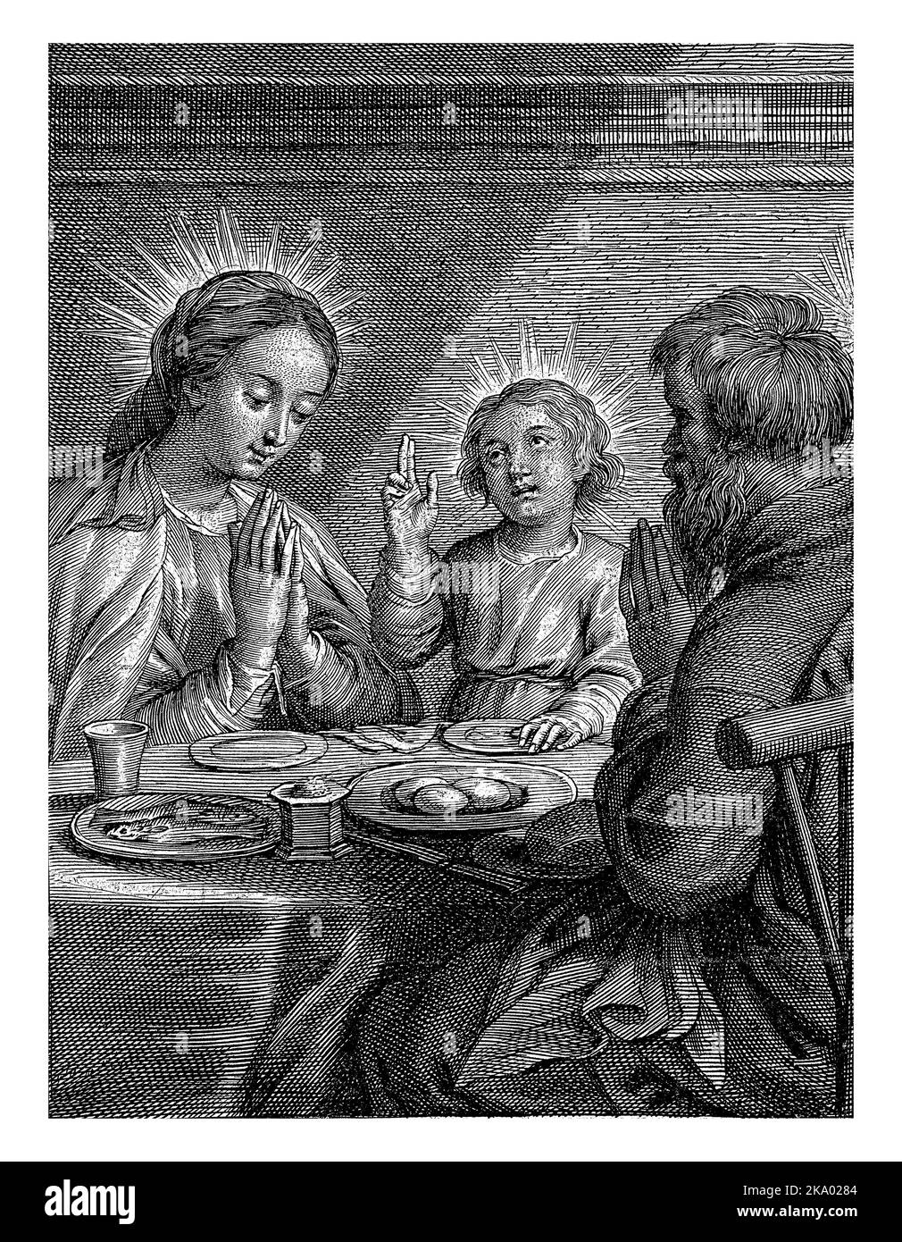 Mary, Joseph and the Child at a set table. Mary and Joseph hold their hands together, the Child blesses the meal. Stock Photo