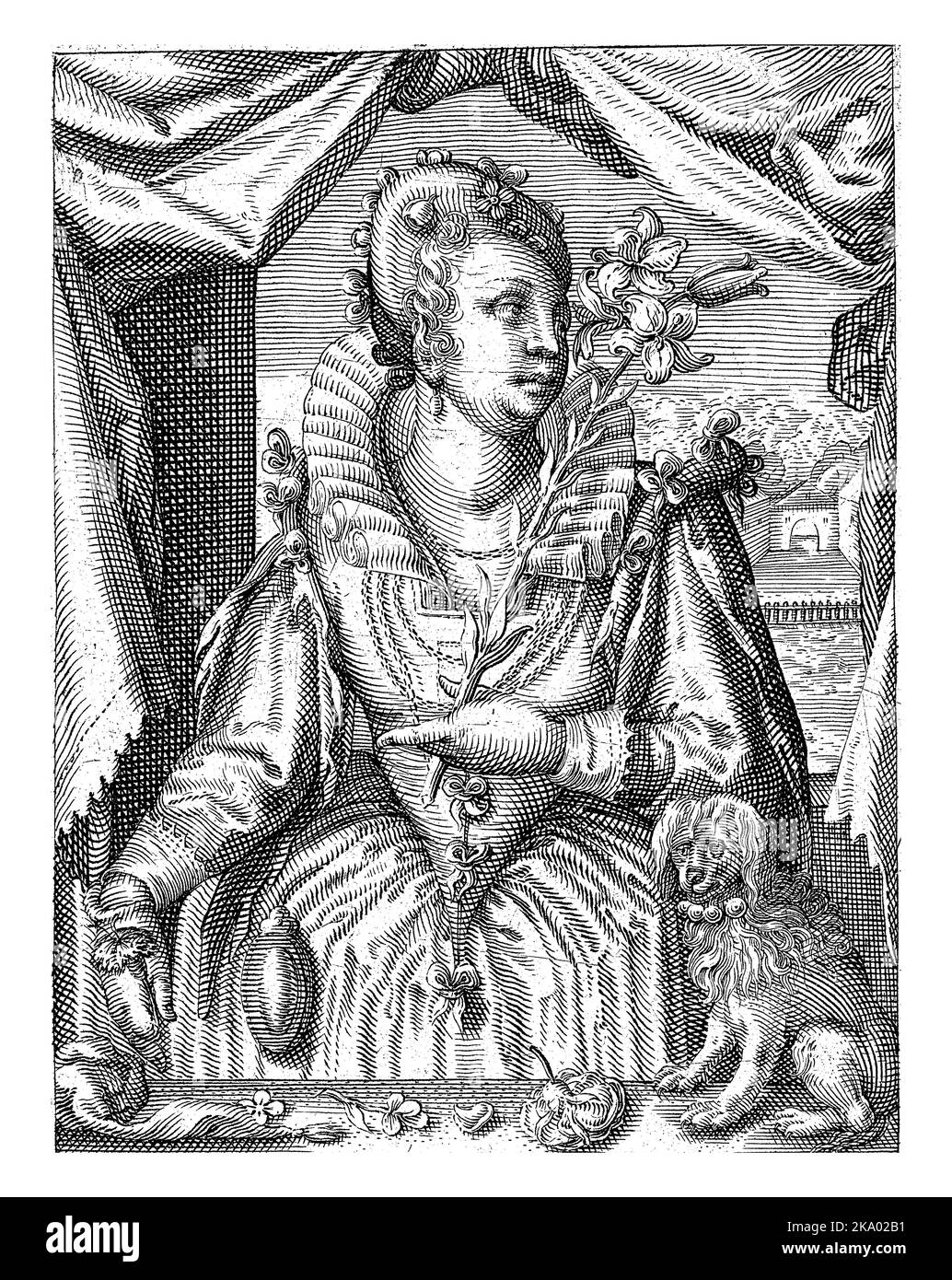 An elegant lady, standing behind a table, holds a flower branch in her ...