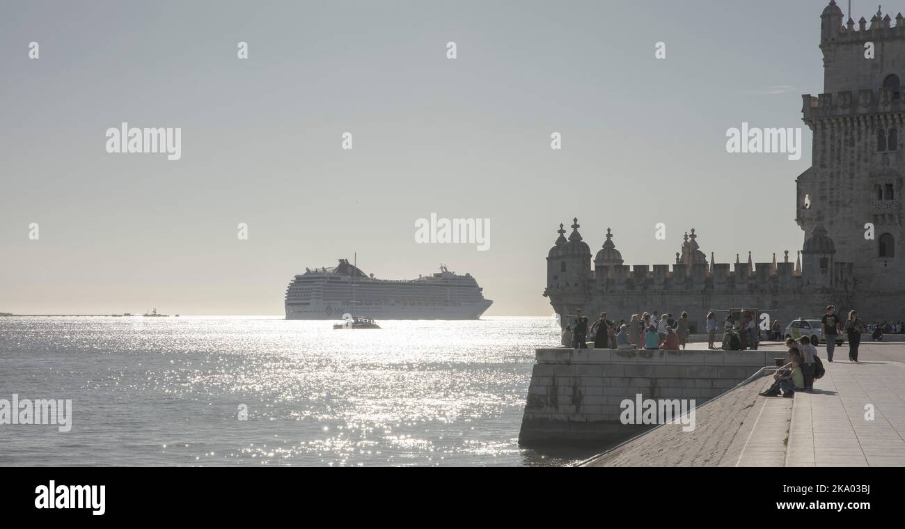 A cruise ship sails past the Belem Tower on the banks of the River Tagus, Lisbon, Portugal Stock Photo