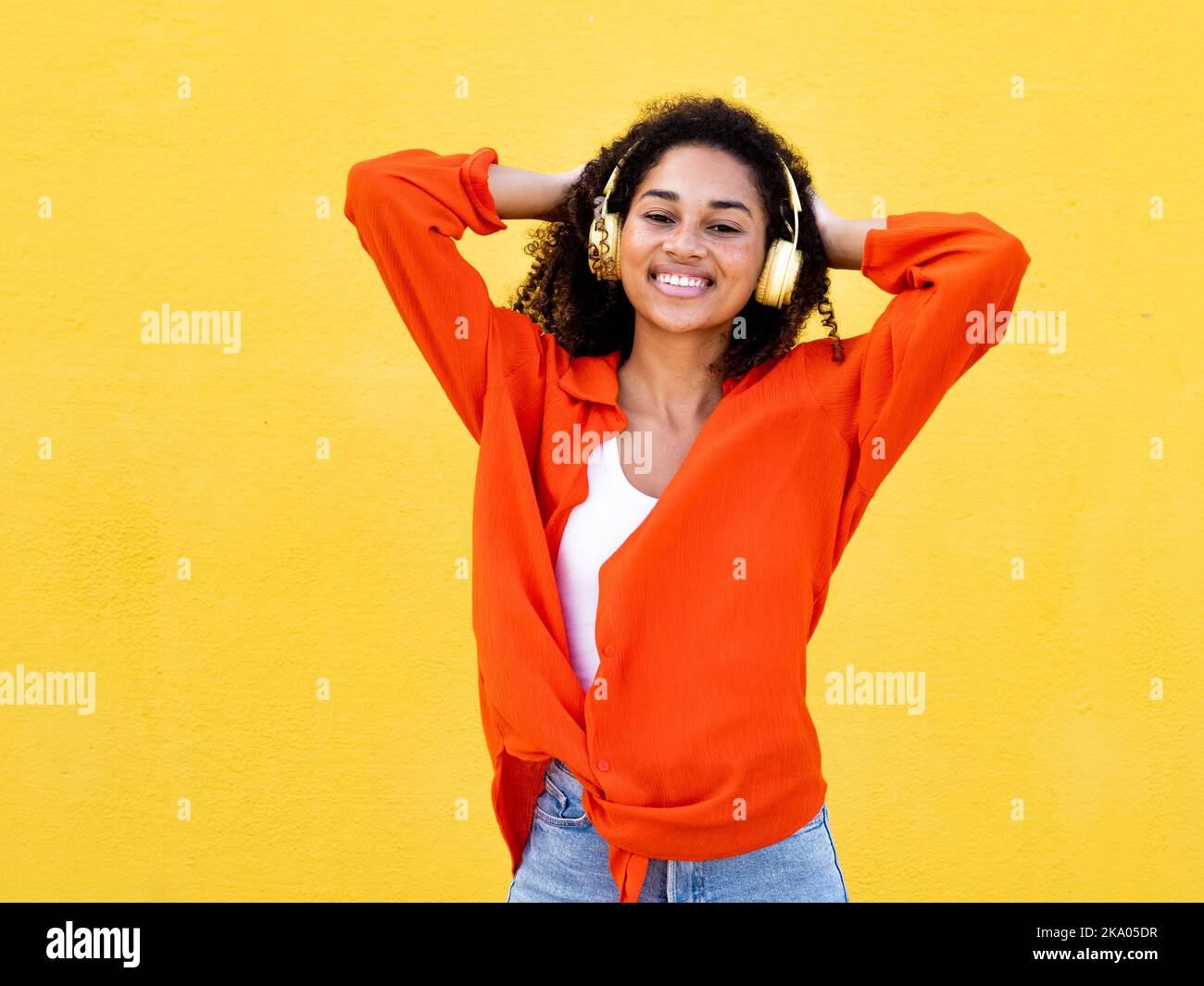 Portrait of a happy african american girl wearing headphones and ...
