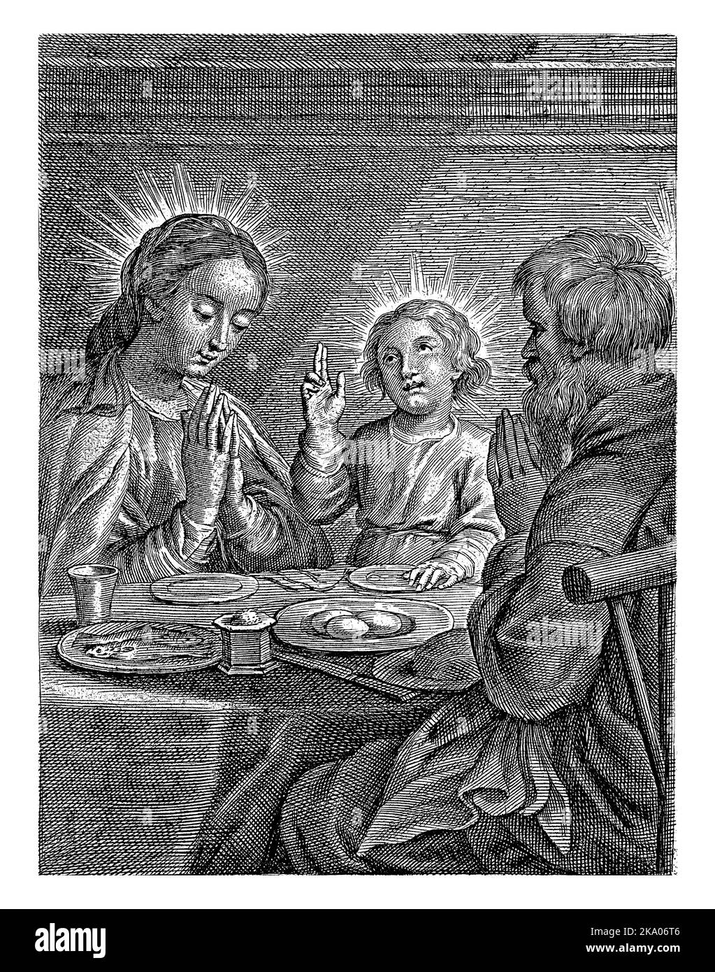 Mary, Joseph and the Child at a set table. Mary and Joseph hold their hands together, the Child blesses the meal. Stock Photo