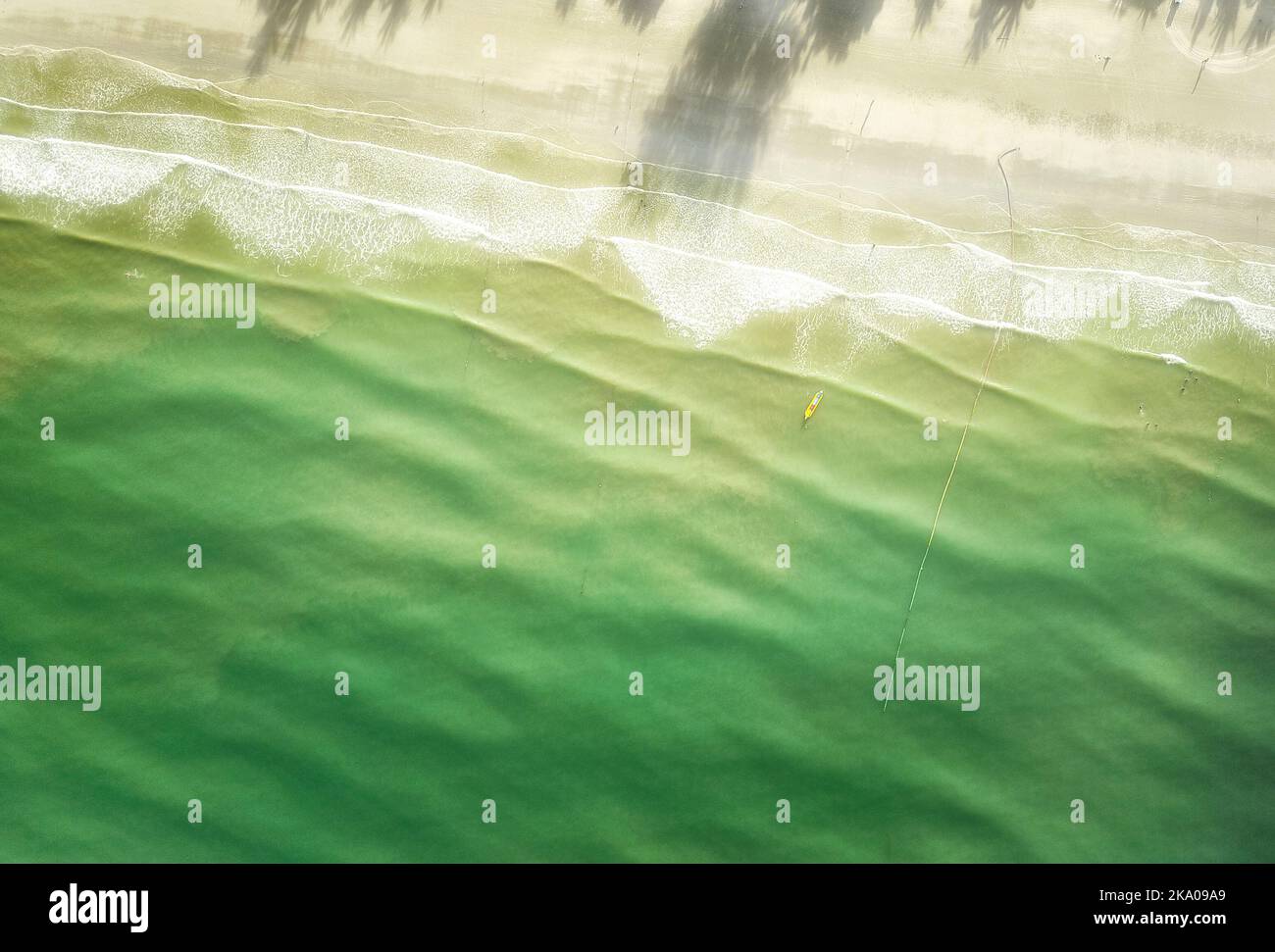 Top view of a banana boat, waves and shadow from the tree at chenang ...