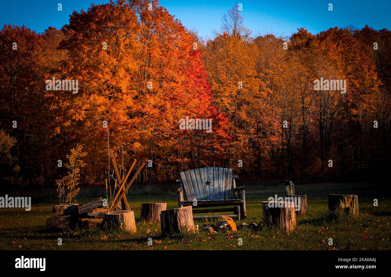 Landscape of a firepit and seating during the beautiful autumn colors Stock Photo