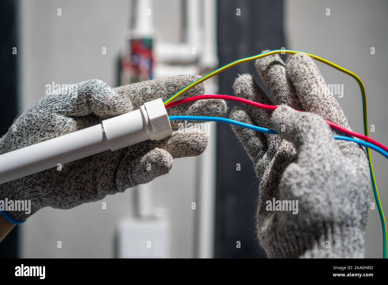 Electrician pulling wire into PVC Conduit Stock Photo Alamy