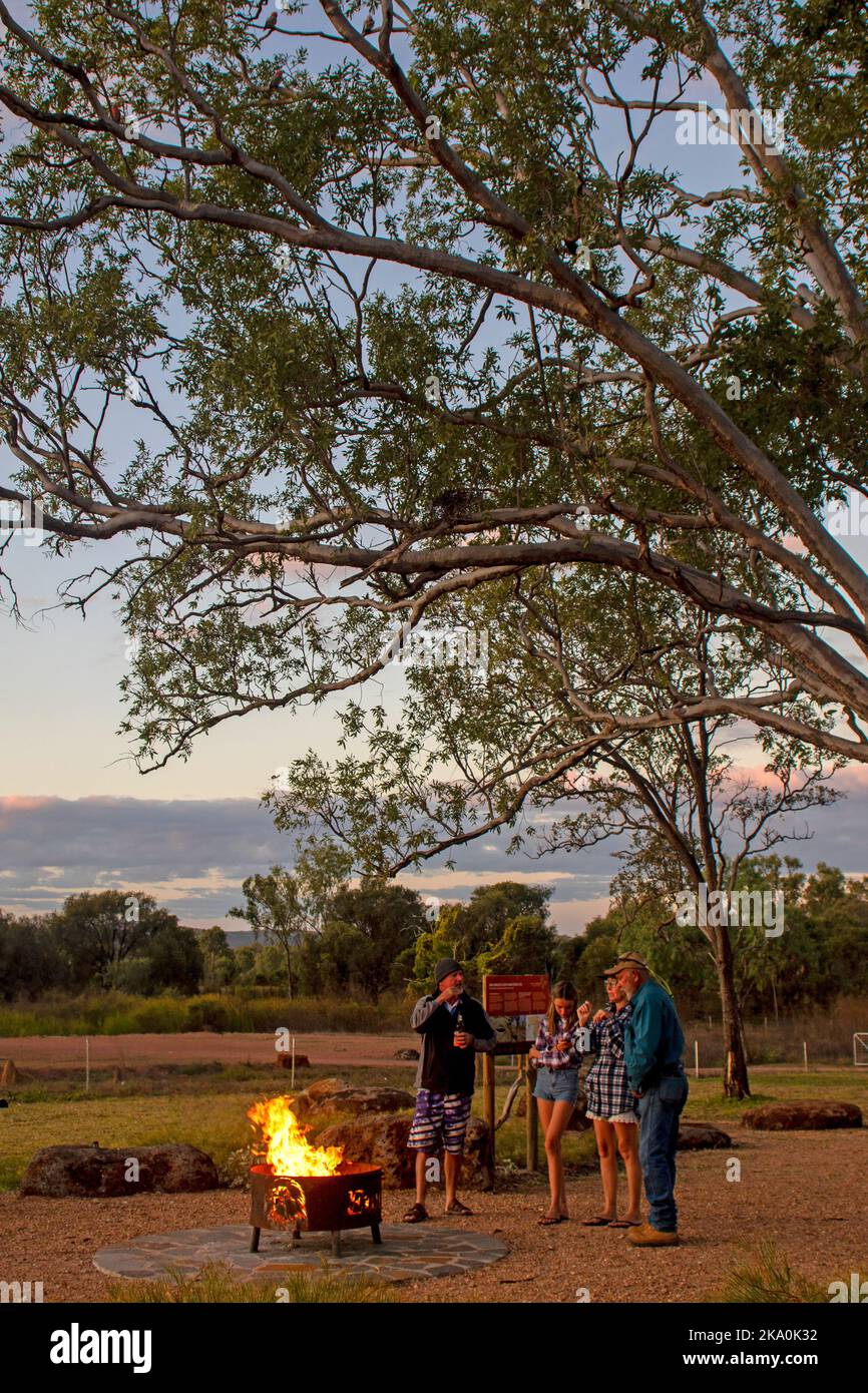 Visitors standing around the fire pot at Talaroo Hot Springs Stock Photo