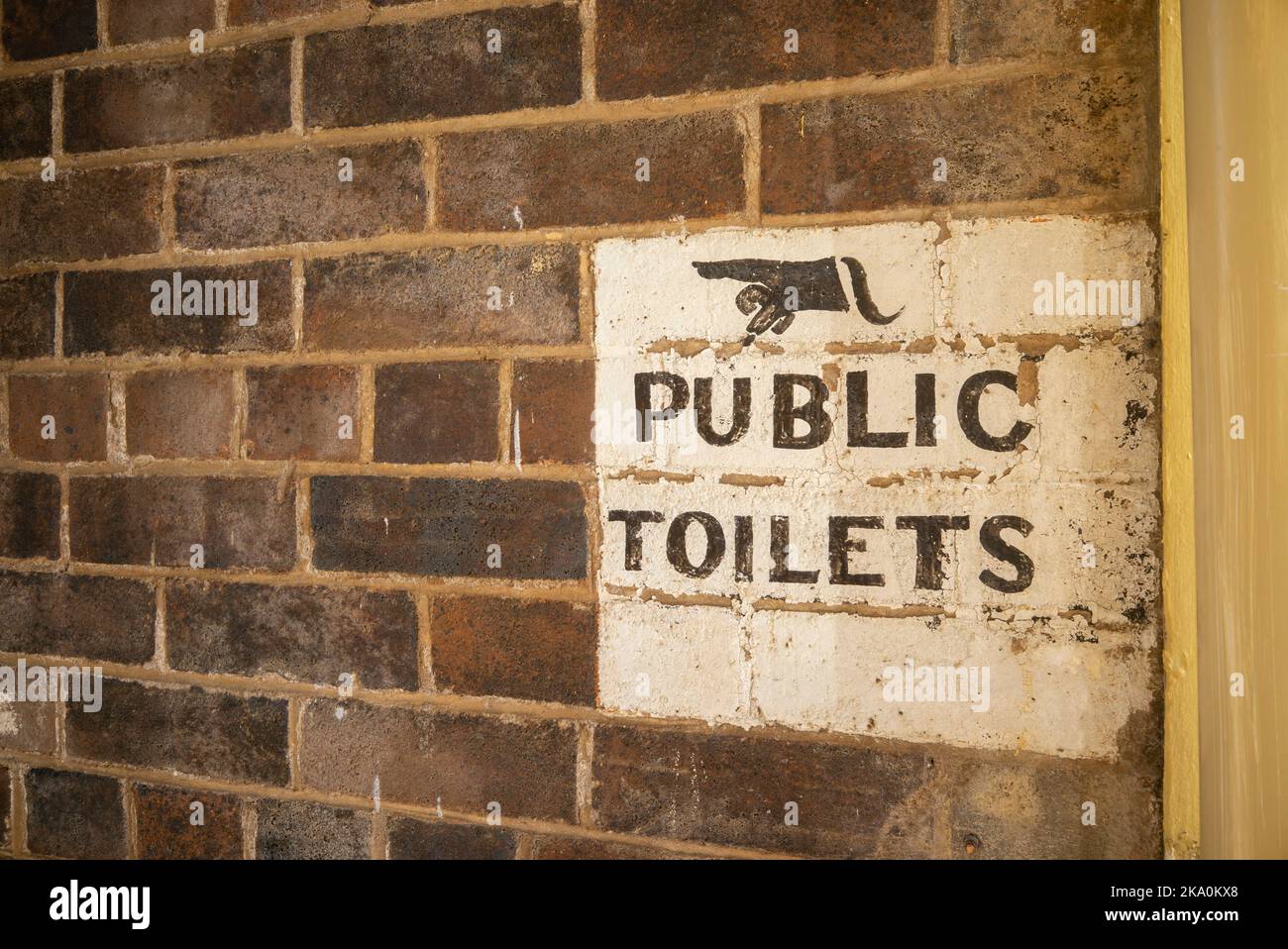 old school public toilet sign in alleyway off the main street in glen