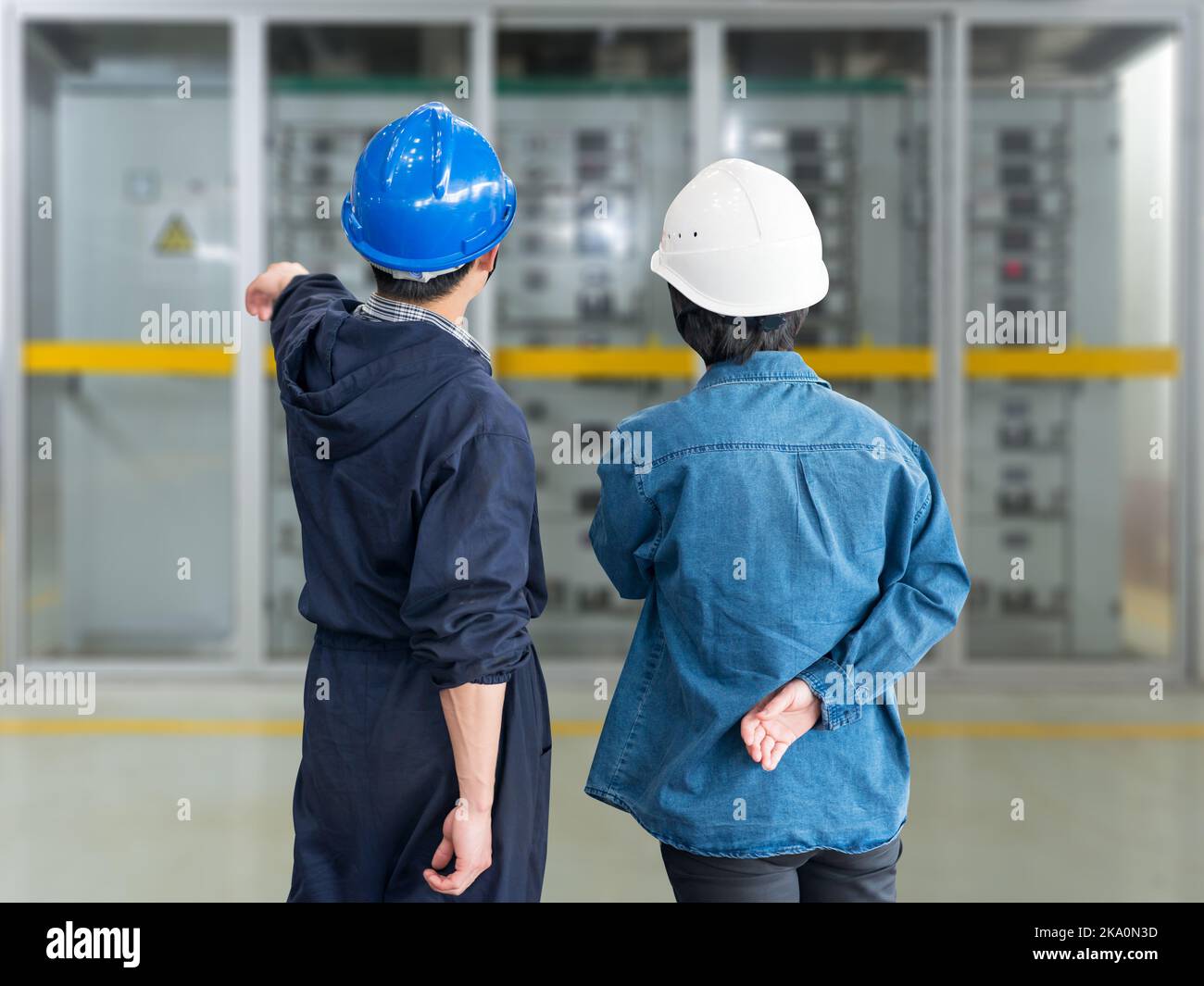 A team of construction workers with helmets at work place in a factory Stock Photo