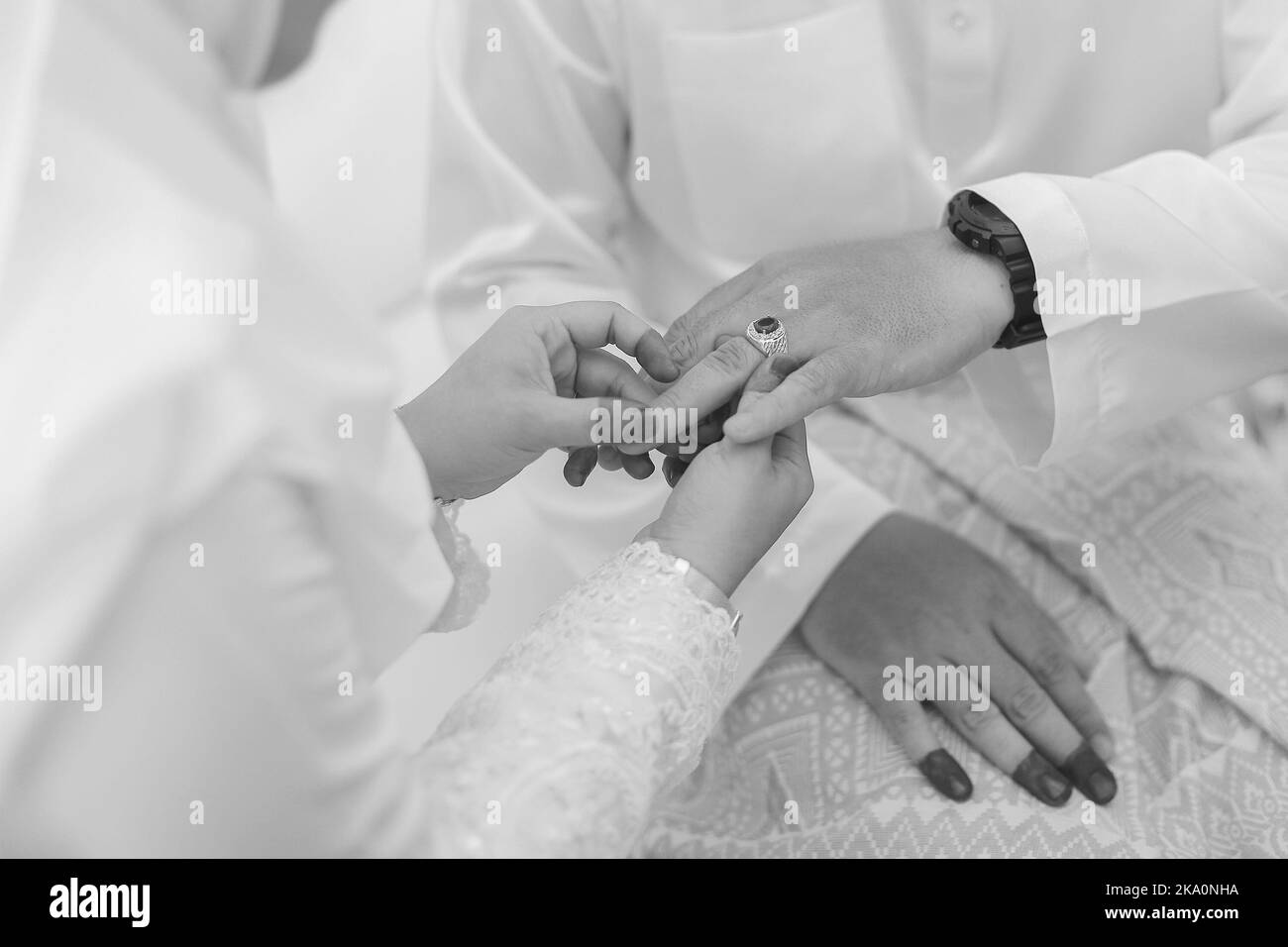 Bride put a wedding ring on groom hand Stock Photo Alamy