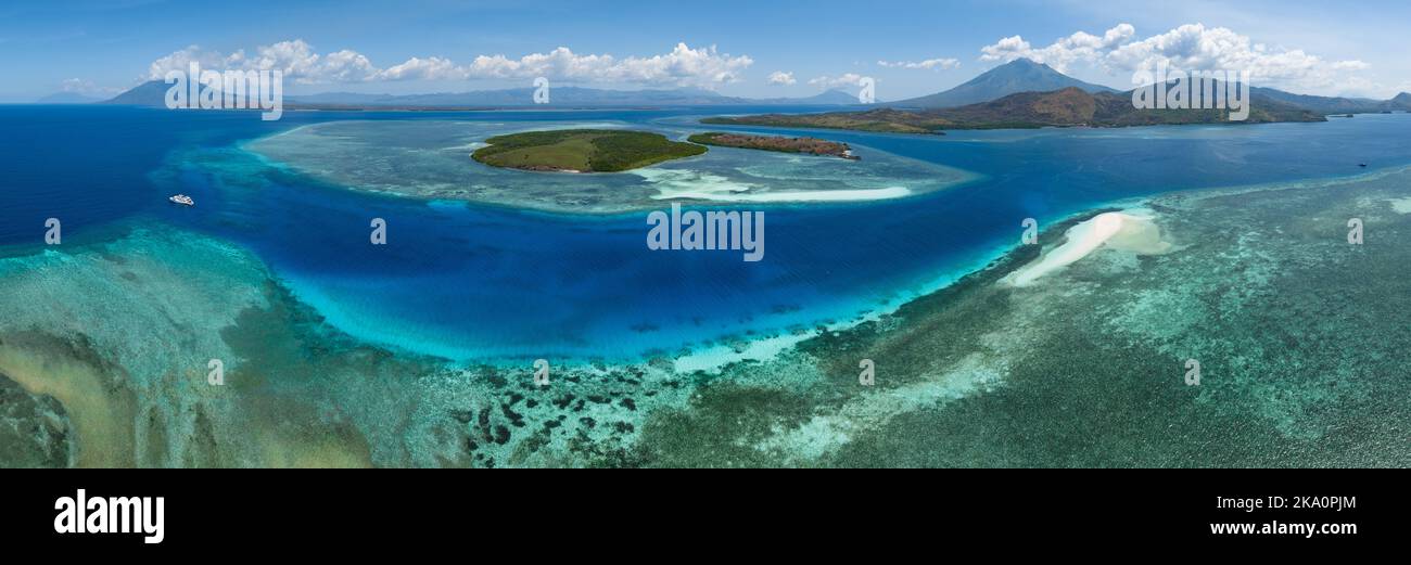 A beautiful coral reef fringes a channel in the Lesser Sunda Islands of Indonesia. This tropical region is home to high marine biodiversity. Stock Photo