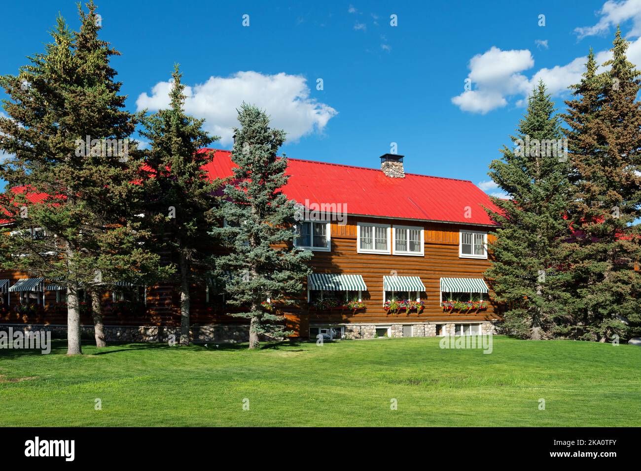 Facade of the Post Hotel in the midst of pine trees, Lake Louise, Alberta, Canada. Stock Photo