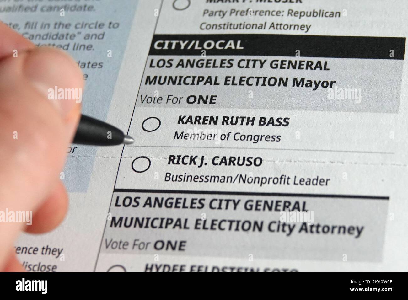 Los Angeles, California / USA - Oct. 30, 2022: A pen is shown about to select a bubble on a mail-in voting ballot for either Karen Bass or Rick Caruso. Stock Photo