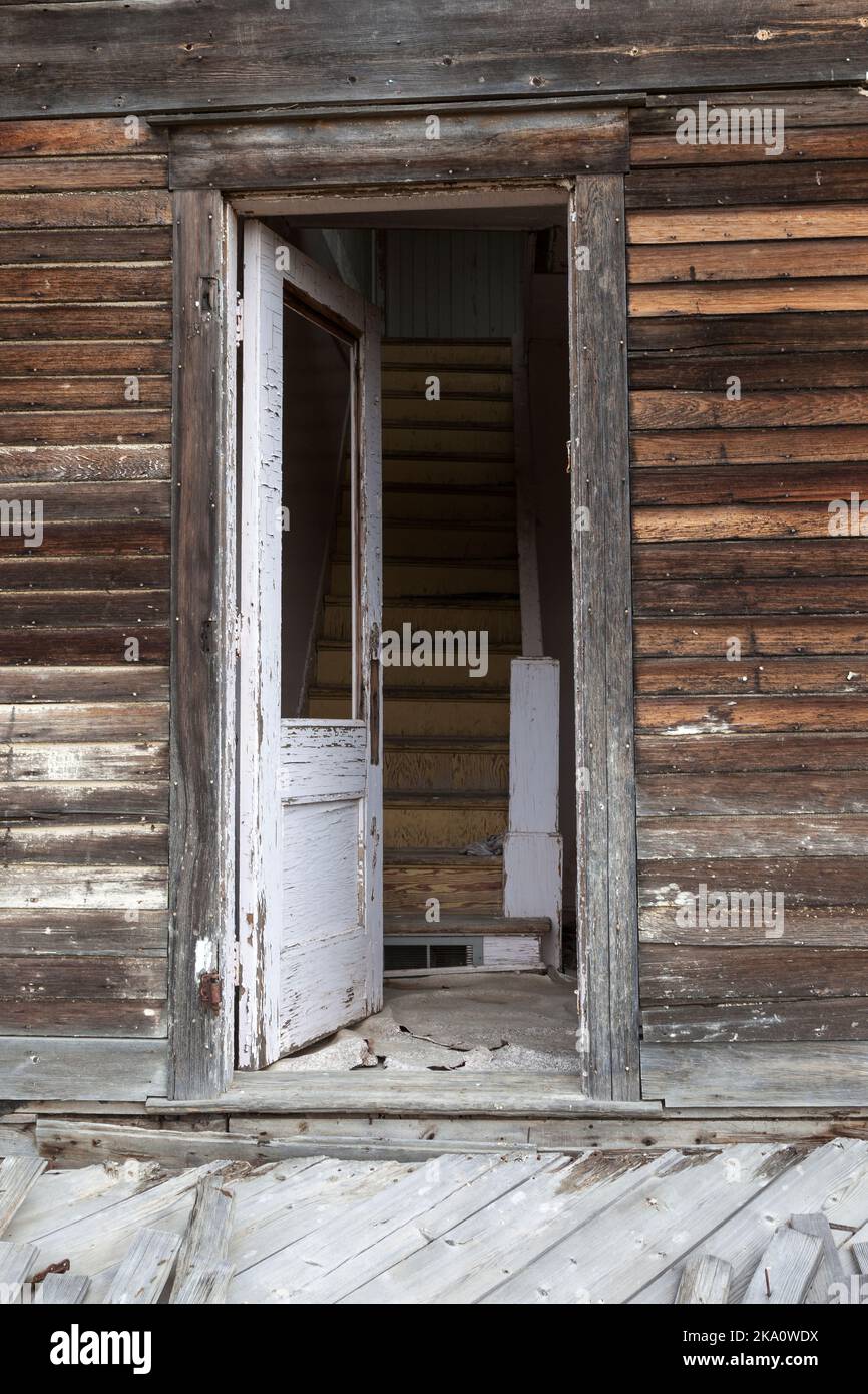 The open door invites the curious up the stairway at an abandoned farmhouse on the Saskatchewan prairie near the town of Mankota. Stock Photo