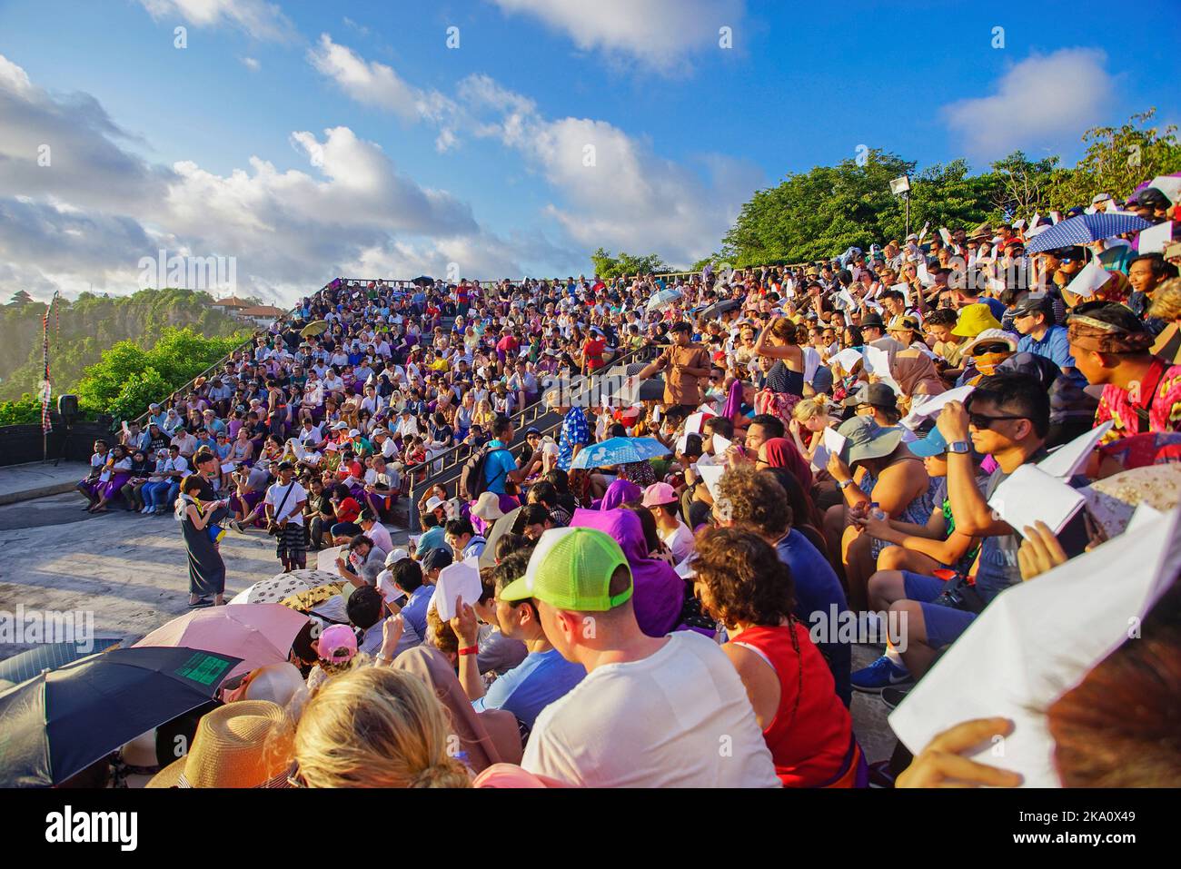 Bali, Indonesia - April 19: Tourists watch traditional Balinese Kecak Dance at Uluwatu Temple on Bali, Indonesia. Kecak (also known as Ramayana Monkey Stock Photo