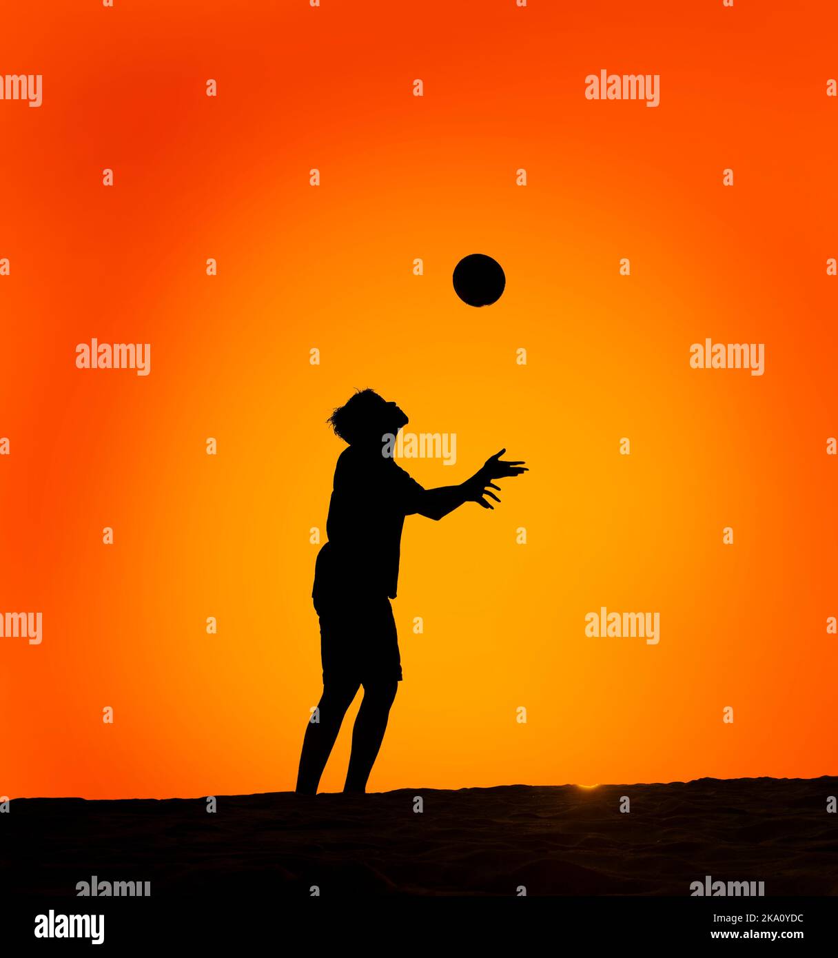 Silhouette of a man playing football Stock Photo