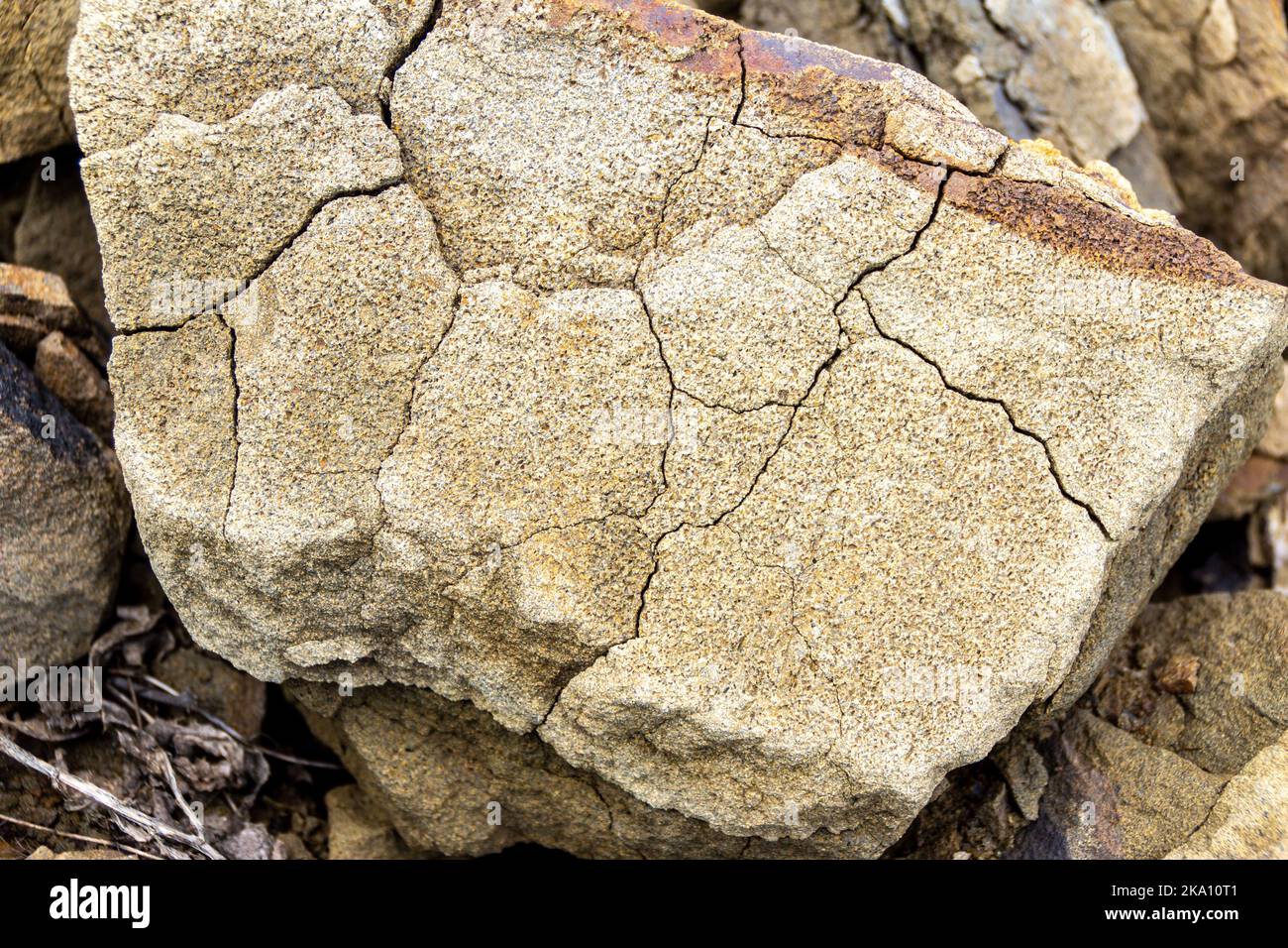 a piece of sandstone cracked under the influence of atmospheric phenomena, selective focus Stock Photo