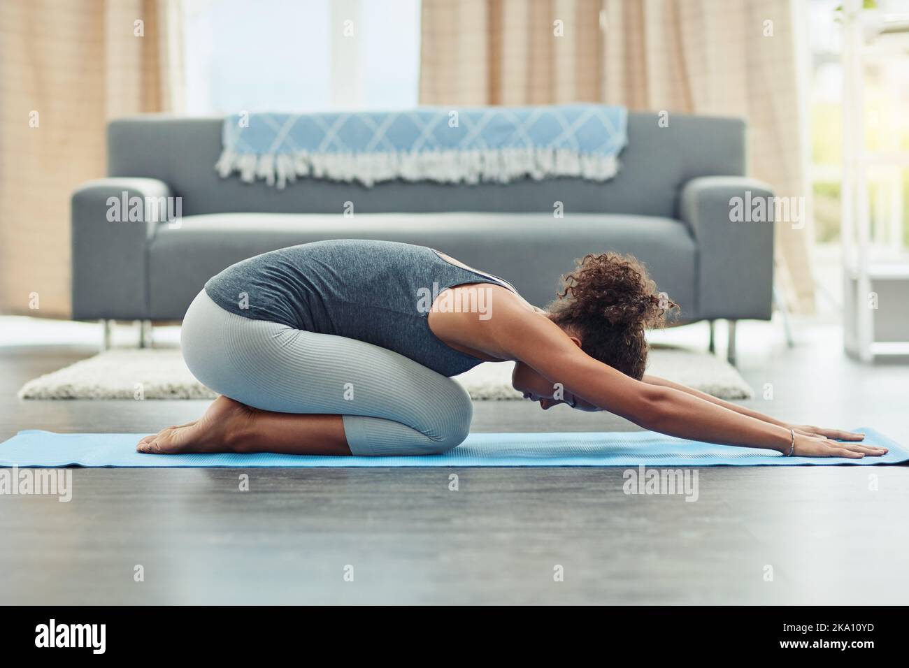 Breathing is important in yoga. an attractive young woman practicing yoga at home. Stock Photo