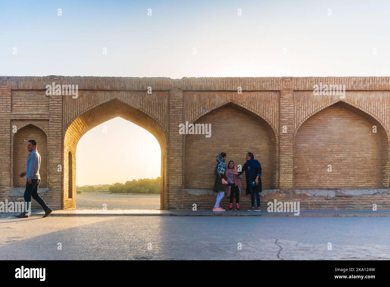 Isfahan, Iran - August 2018: Female Iranian tourists with headscarf on the Khaju bridge in Isfahan, Iran. Iranian tourists or people Stock Photo