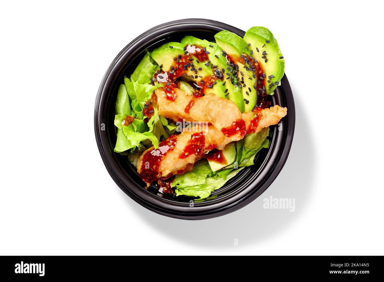 Japanese salad with lettuce, avocado and shrimps tempura dressed with mirin sauce and black sesame Stock Photo