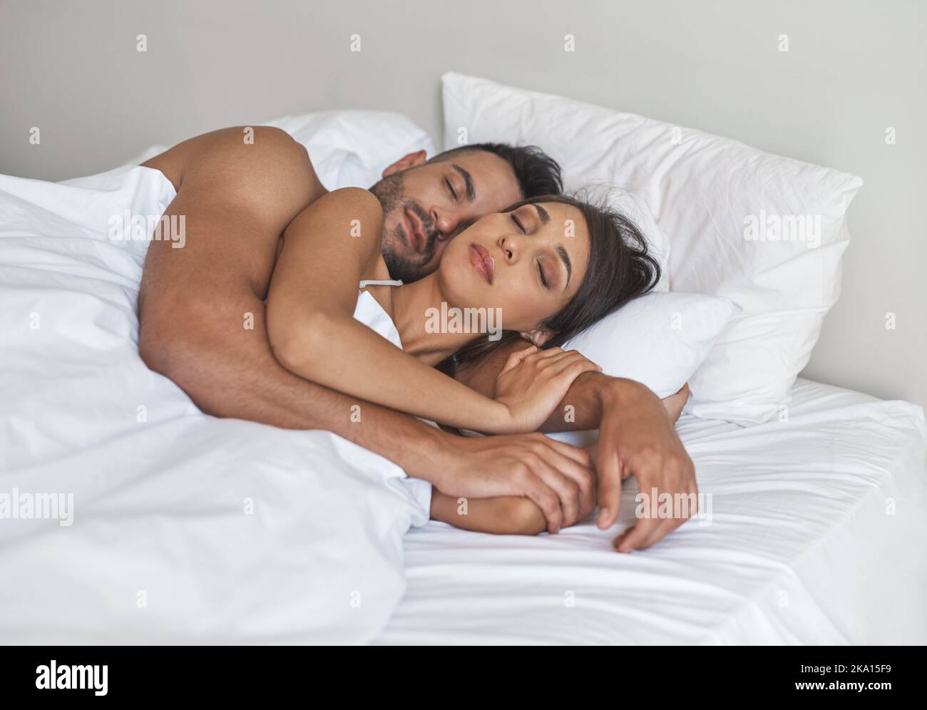 I dream the best when I lay next to you. a young married couple sleeping in bed at home. Stock Photo