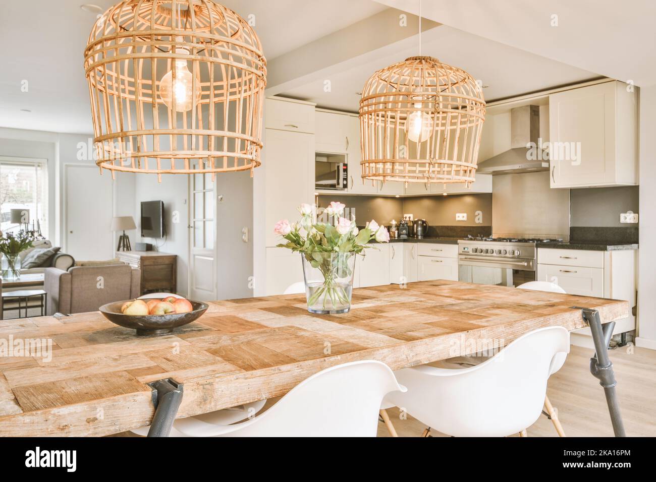 Contemporary open plan kitchen with dining table set and gray sofa in ...