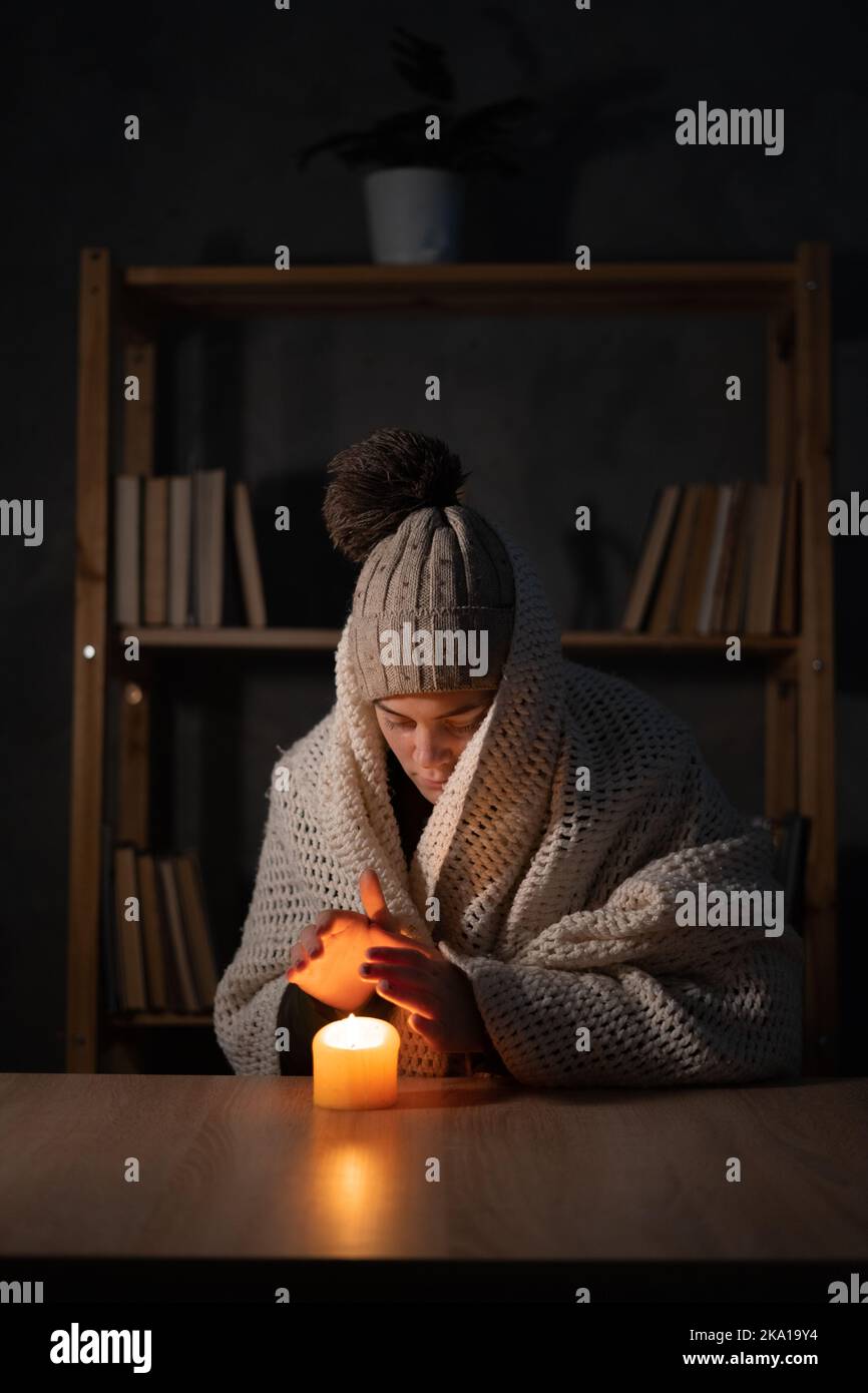 Woman suffers in no heating and no electricity during an energy crisis in Europe causing blackouts. power outage, blackout, load shedding or energy Stock Photo