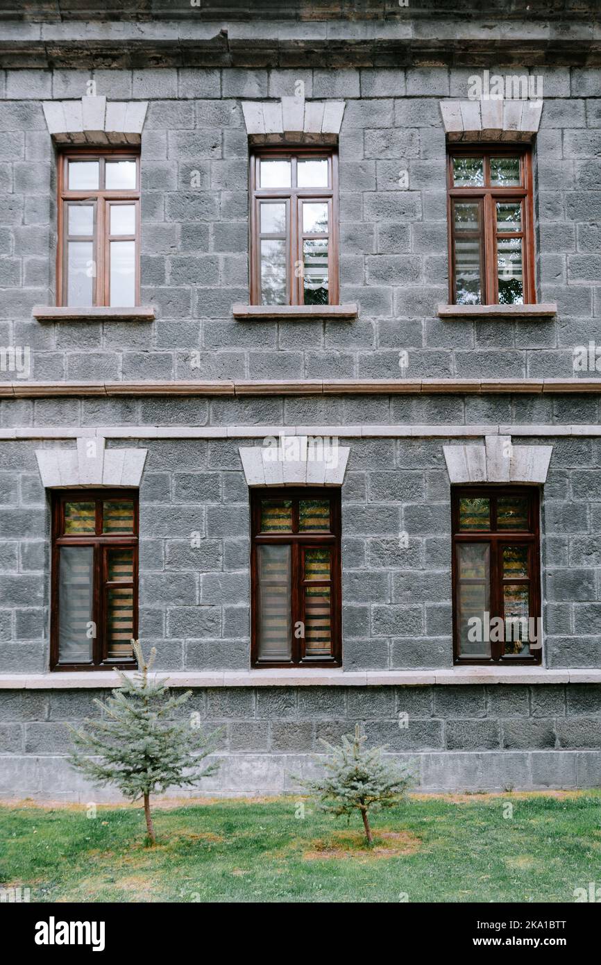 An old classic stone house with windows. Calssic stone walls and windows textures. High quality photo Stock Photo