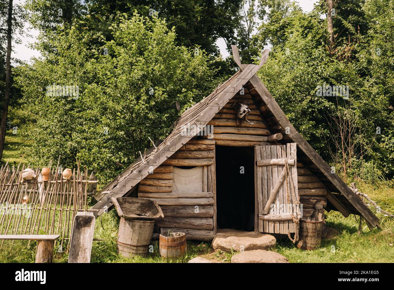 Triangular Logentry Triangular log houses with wooden roofs behind a fence. Montenegro ...