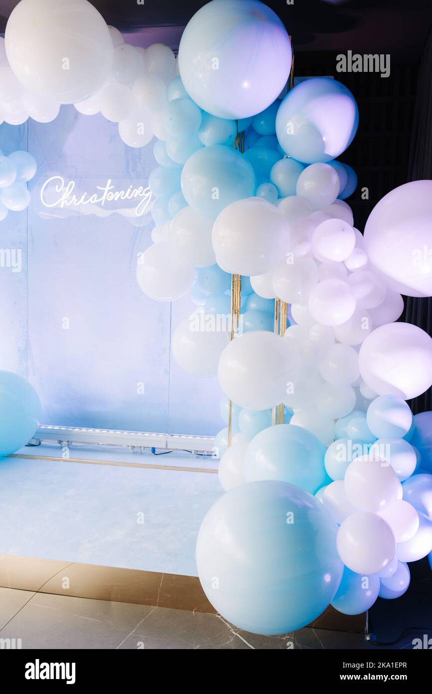 Photo zone for the boy's baptism is decorated with blue balls. Christening in restaurant Stock Photo