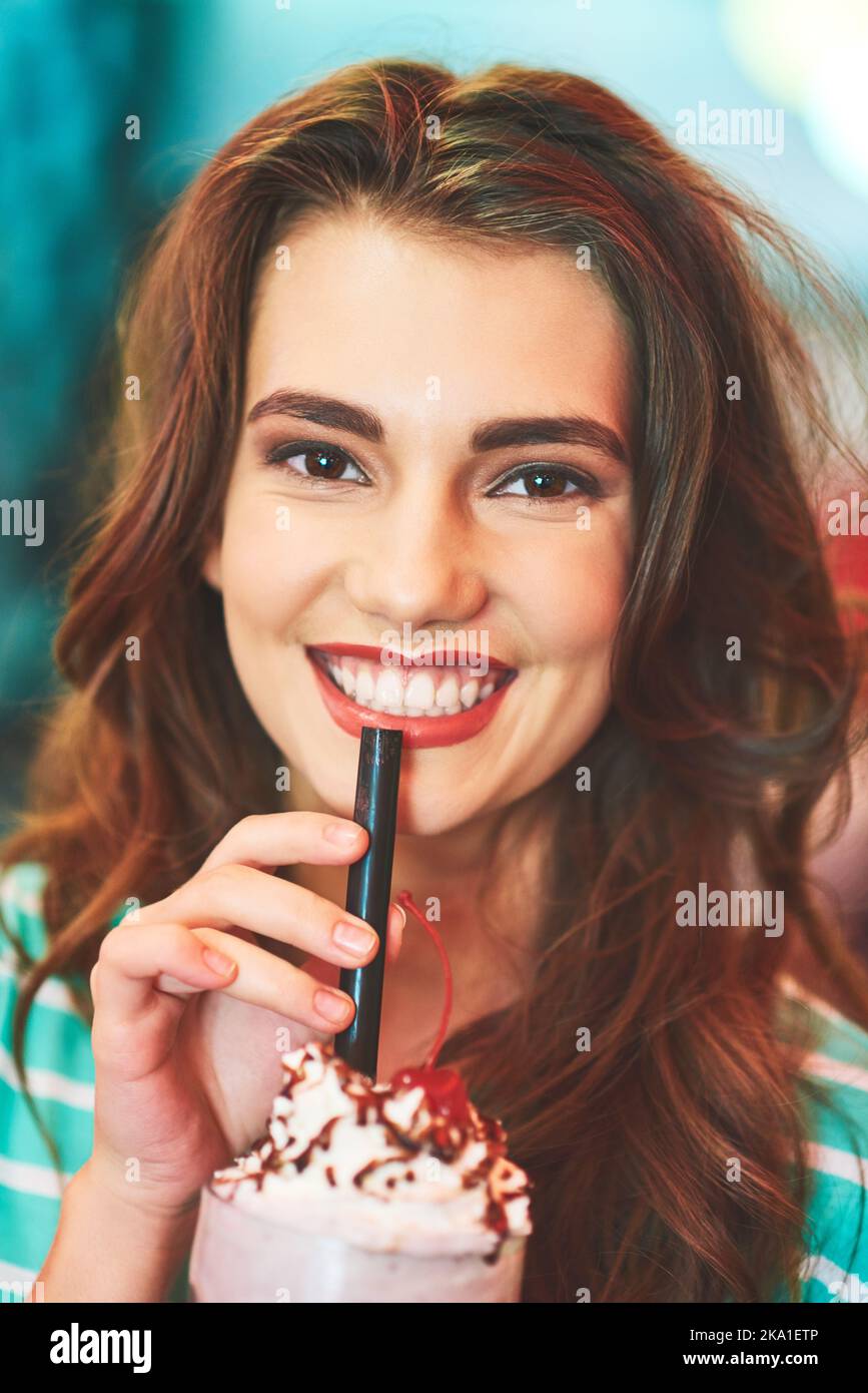 Her favourite milkshakes at her favourite spot. a beautiful young woman