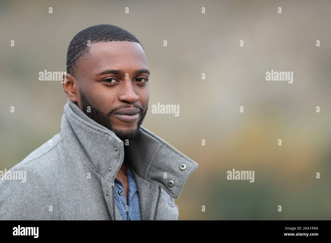 Confident black man looks at you in a park Stock Photo