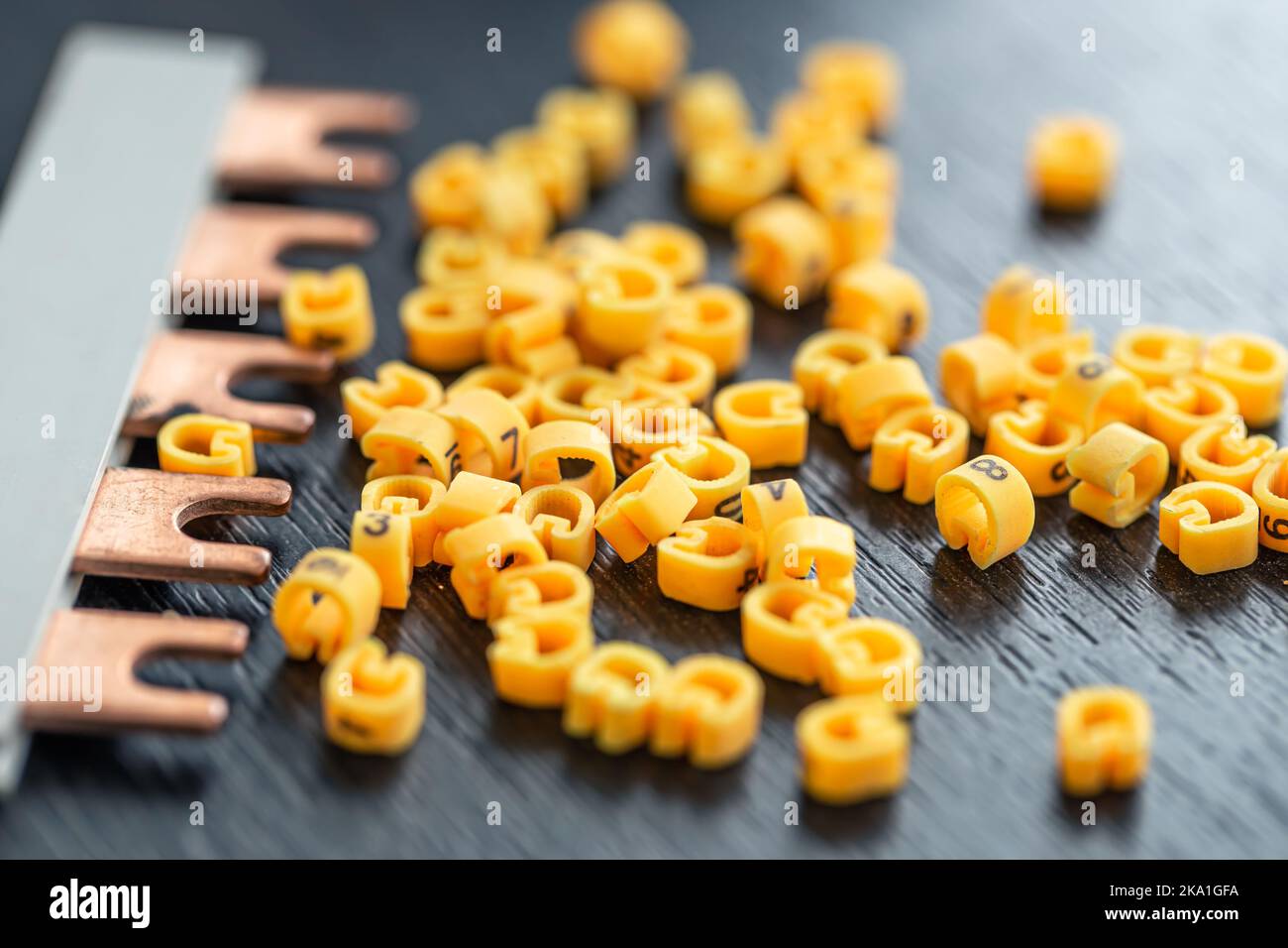 Cable markers scattered on the table, macro shot. Stock Photo
