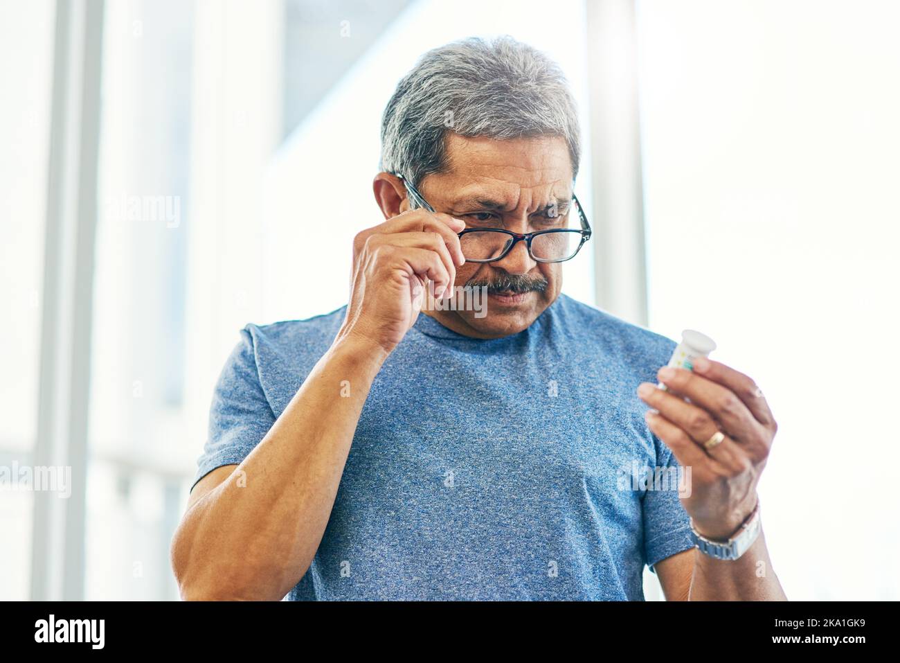 Senior man glasses looks bottle hi-res stock photography and images - Alamy