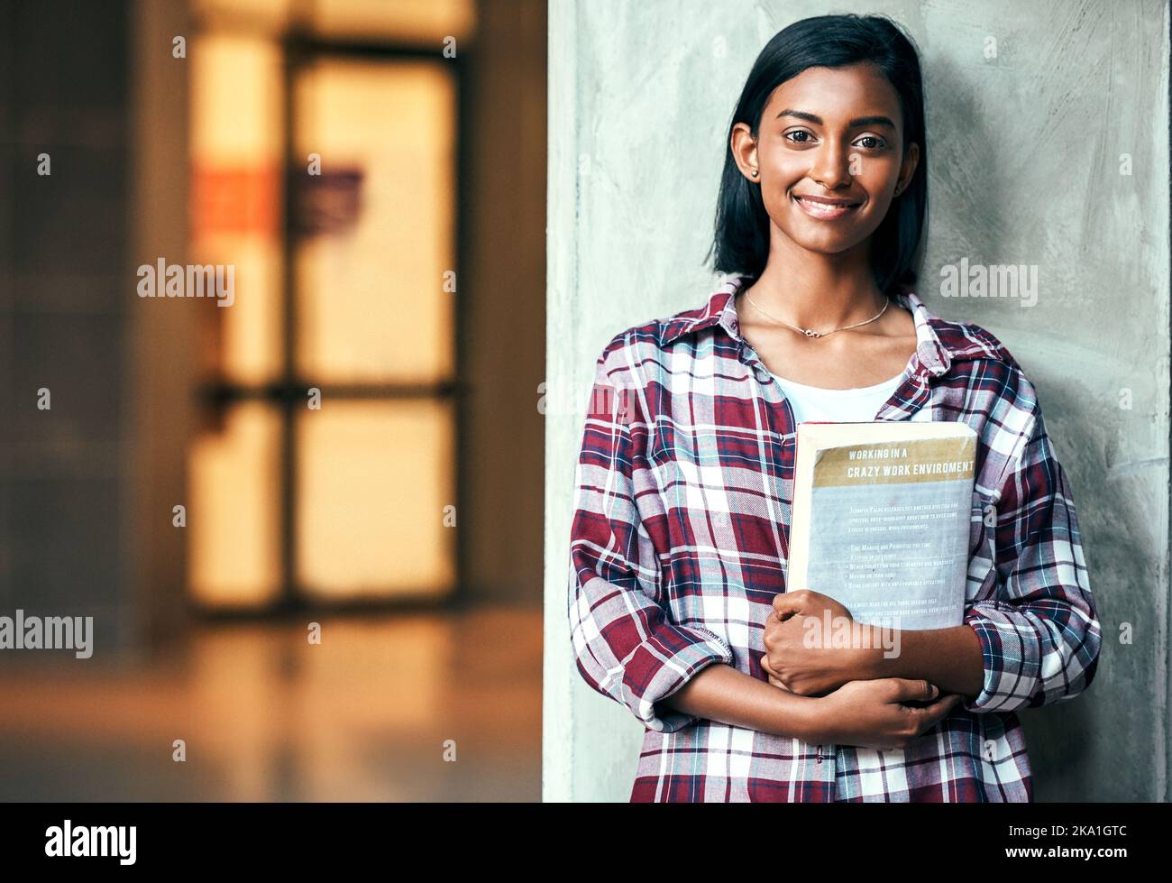 Strive for success in college, so study hard. Portrait of a young female student outside on campus. Stock Photo