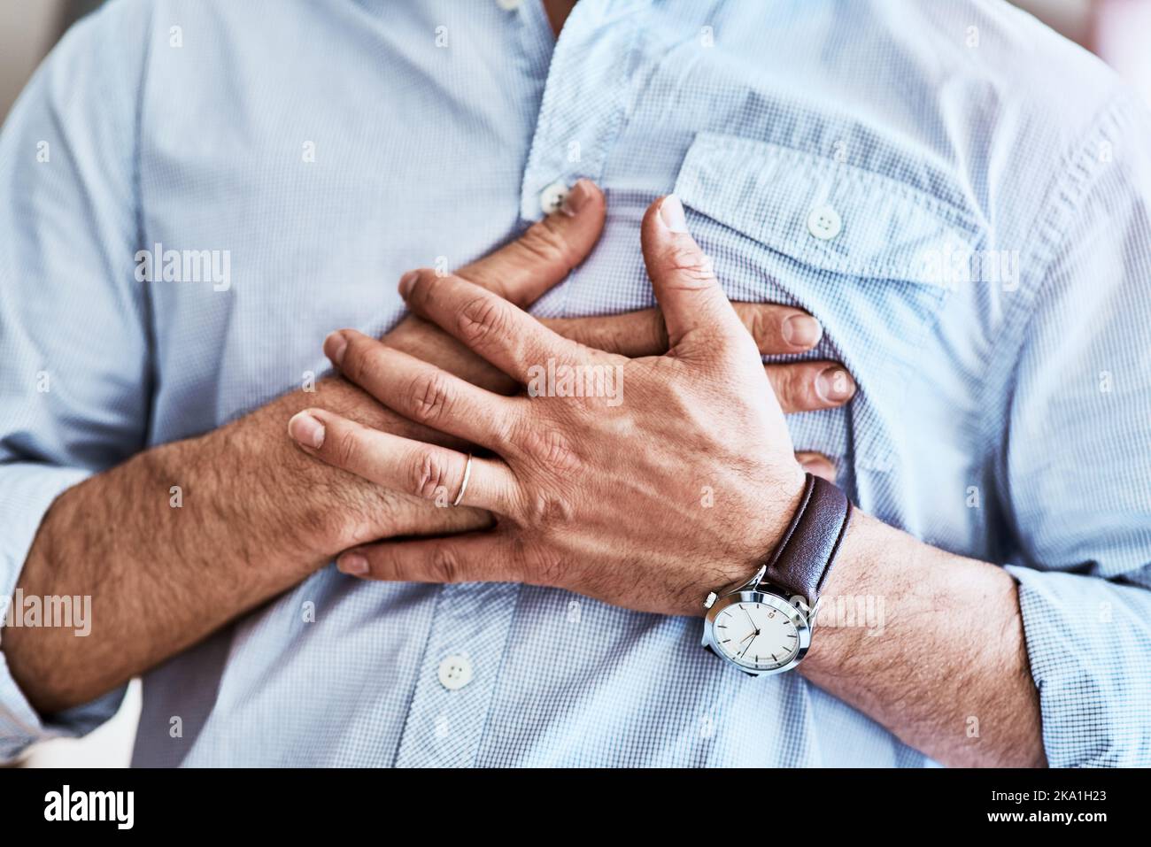 The pain is right here. an unrecognizable man holding his chest while