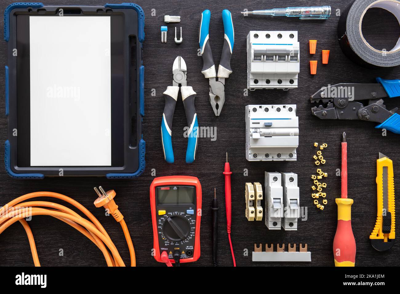 Different electrical tools on wooden background, flat lay. Stock Photo