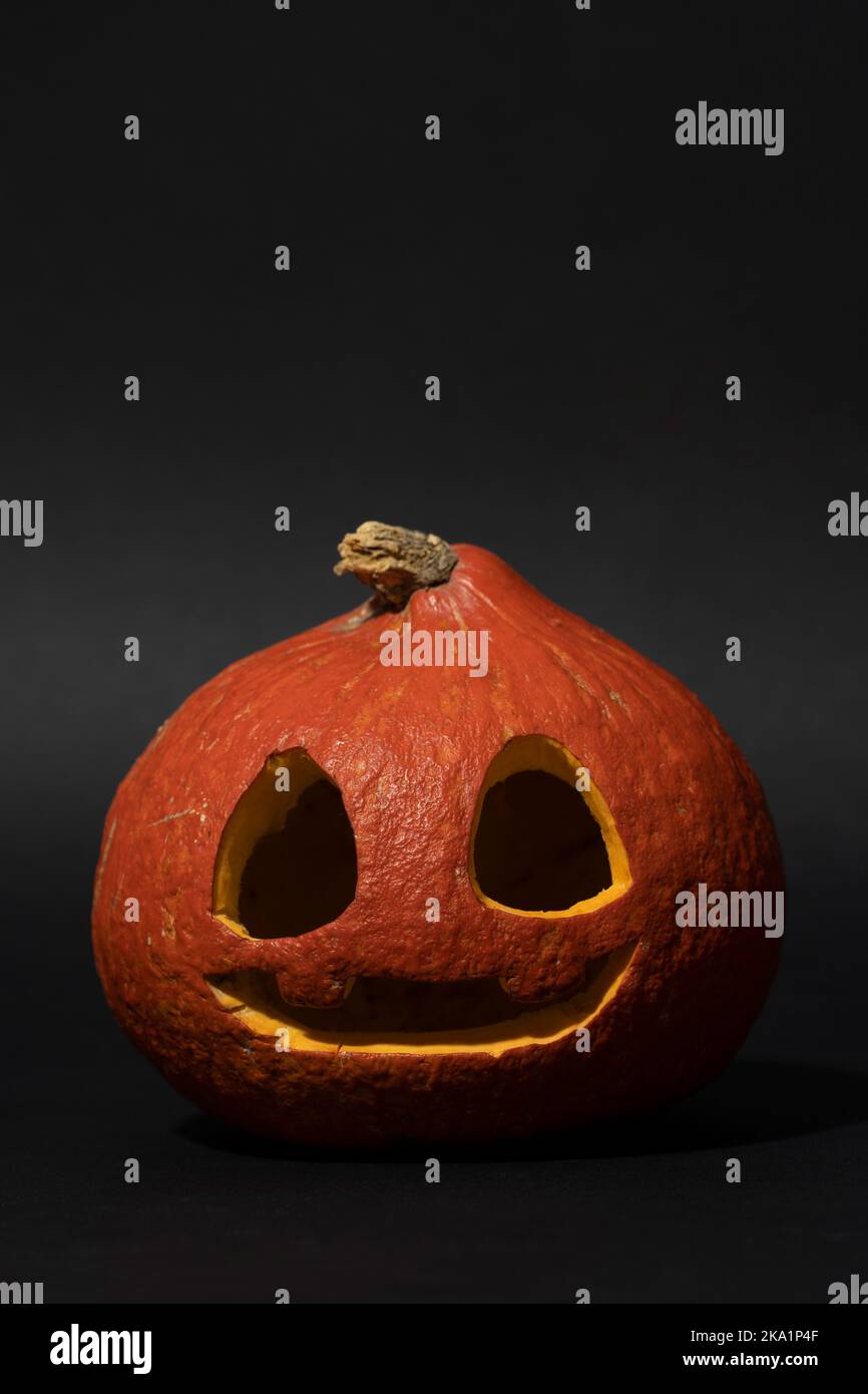 Halloween Jack O' Lantern pumpkin on vertical black background Stock ...