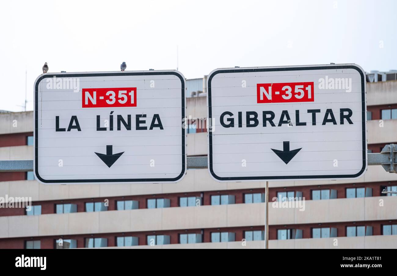 Overhead road signs on dual carriageway with directional arrow symbols
