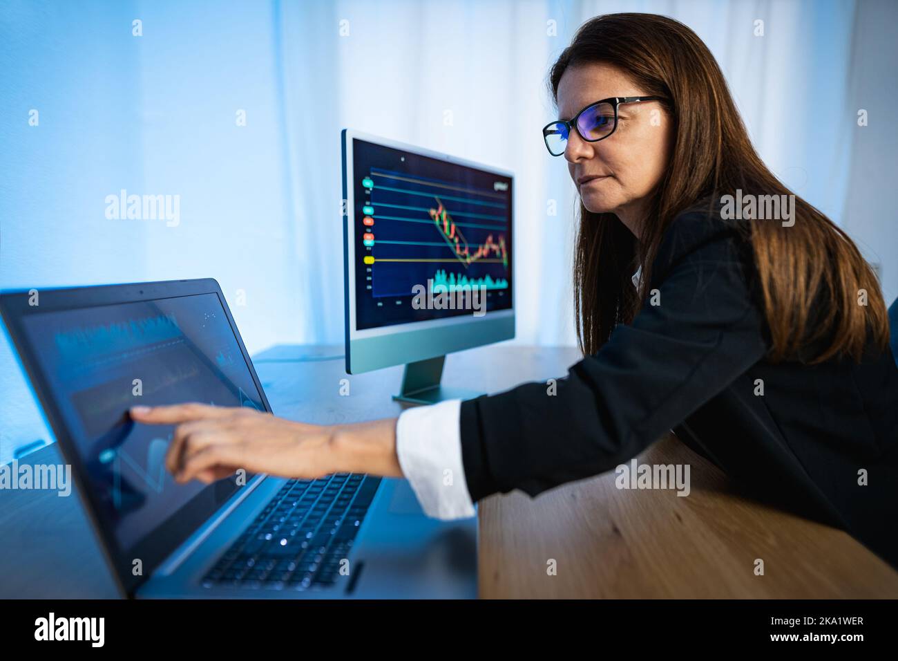 Business trader woman working on financial markets in a modern office Stock Photo