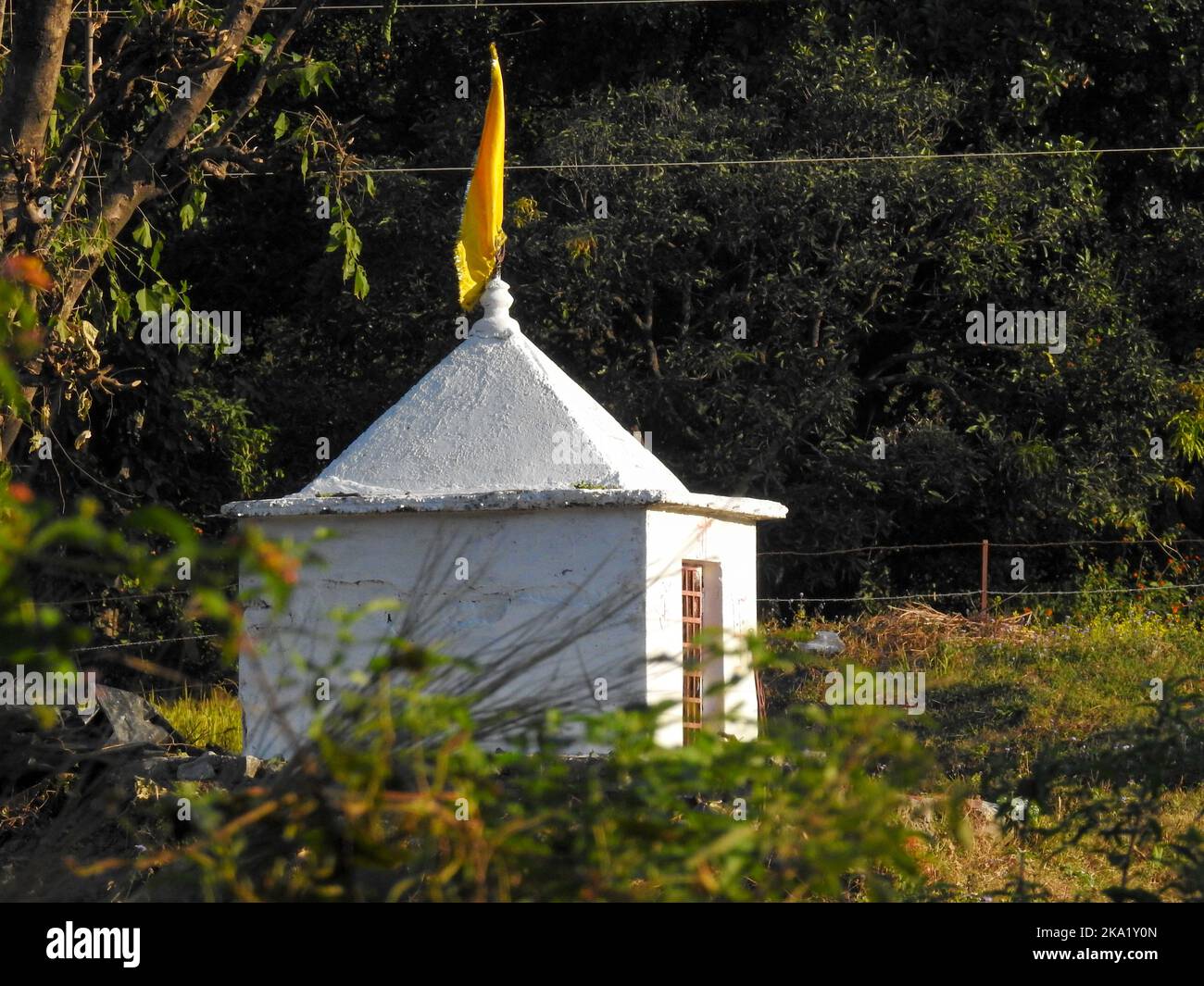A small triangular temple or prayer spot of Hindu deity . These small triangular monument are very common in Hindu Religion as a worship place . Dehra Stock Photo