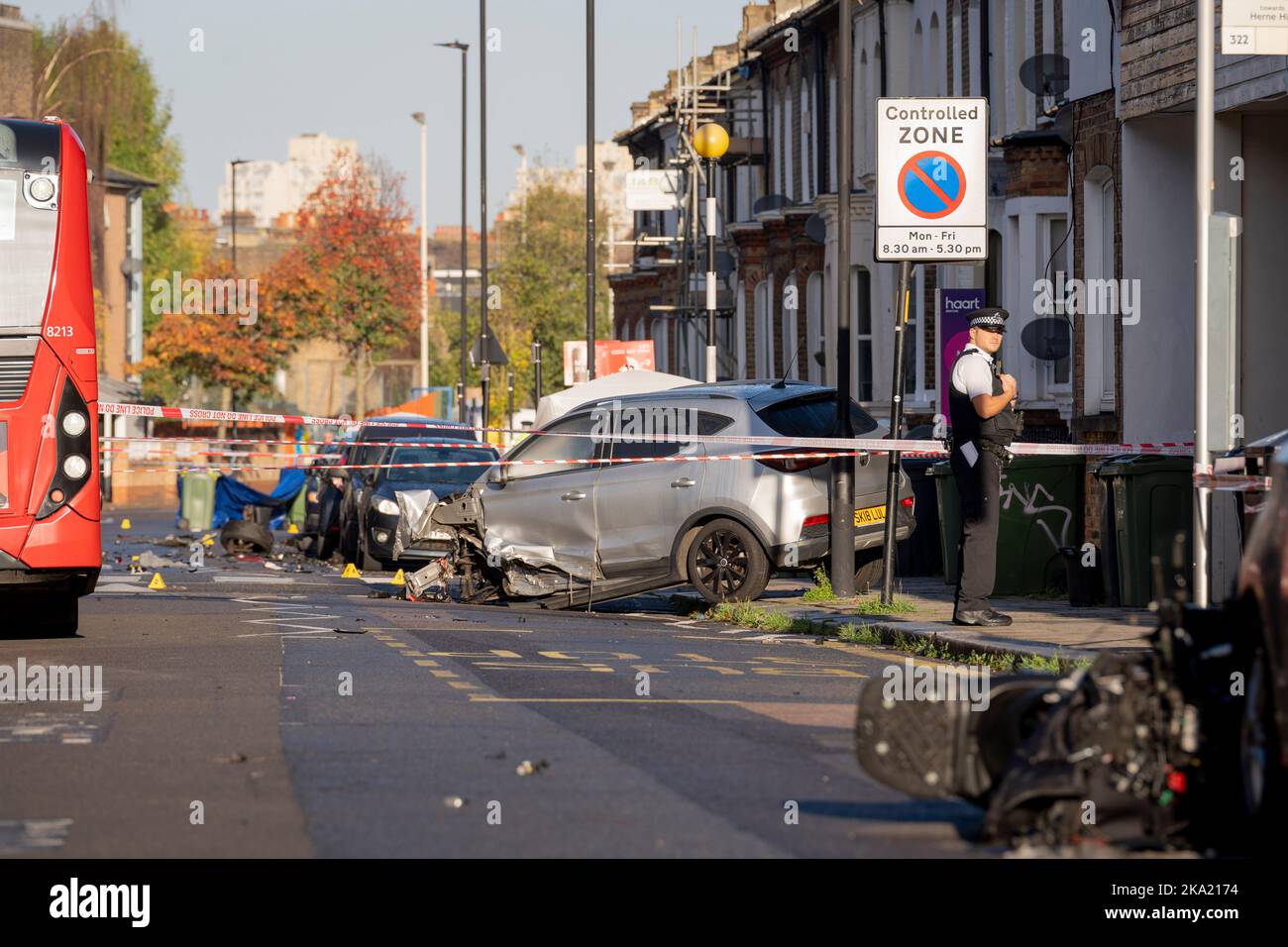 A police officer speaks with local residents the morning after two