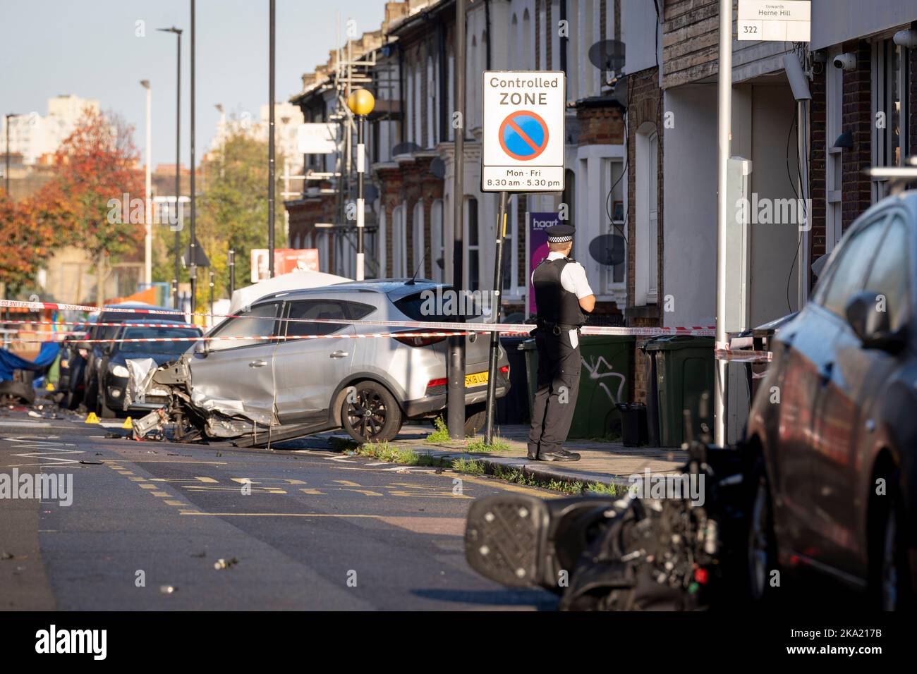 A police officer speaks with local residents the morning after two