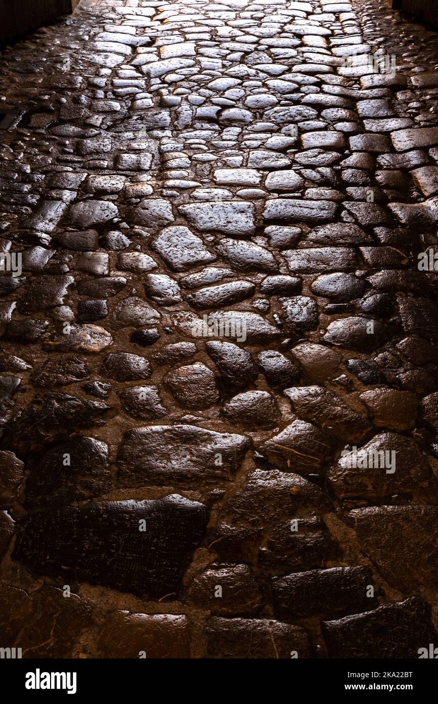 Ancient roman pavement with smooth stones, background and texture Stock