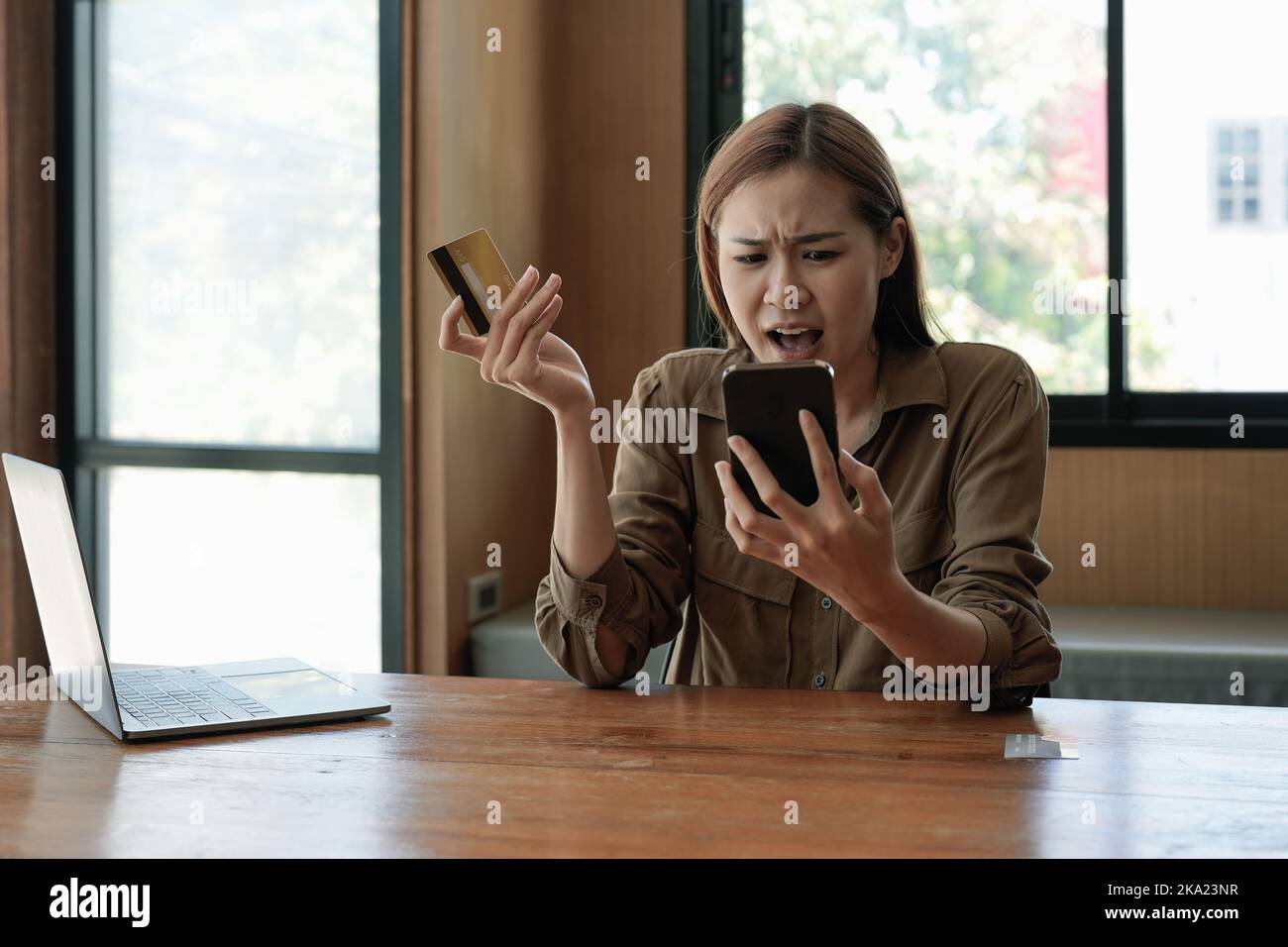 Unhappy young asian female buyer have problems buying online on