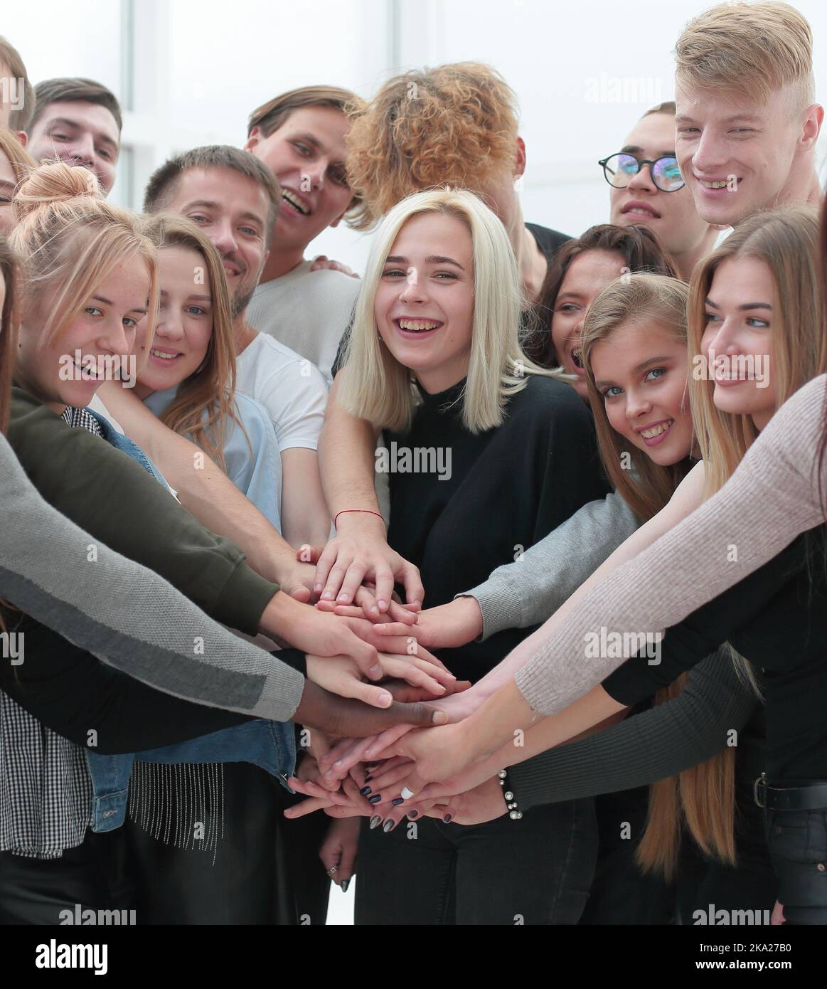diverse young people putting their hands together Stock Photo - Alamy