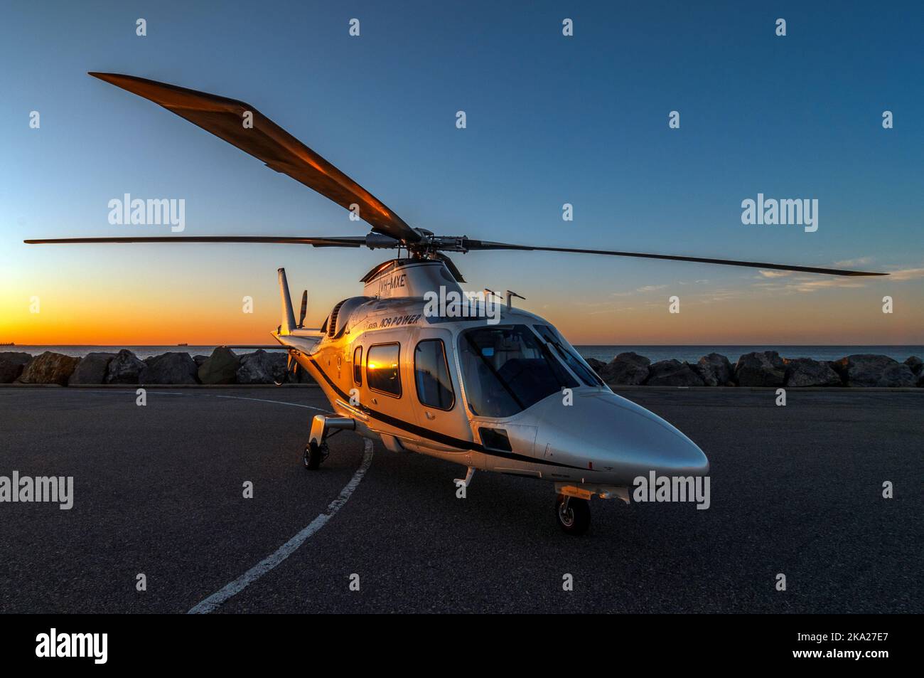 Agusta 109 'Power' executive helicopter at sunset Stock Photo